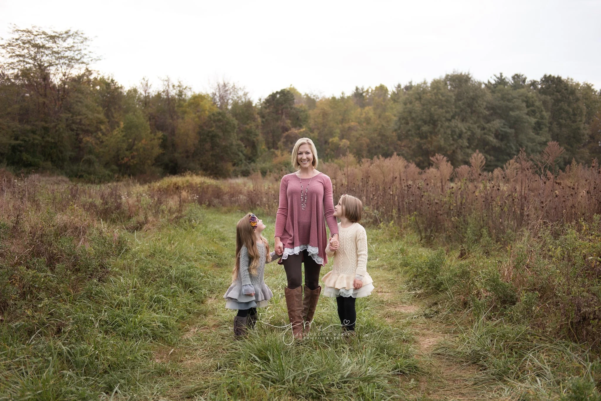 mother and two daughters wear ruffle sweaters for their outdoor fall family photography session in Columbus ohio