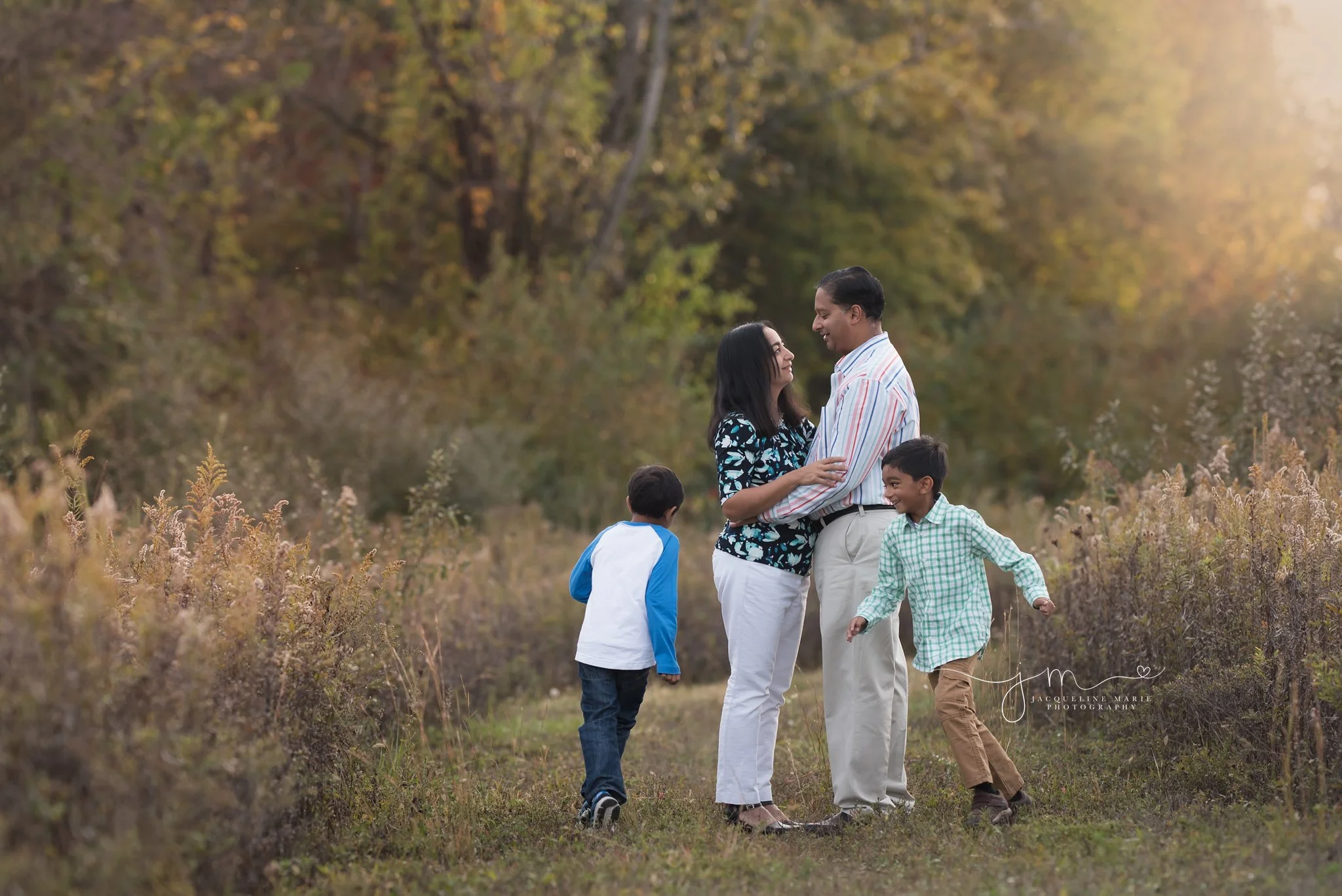two children laugh and run around their parents during family portraits in columbus ohio