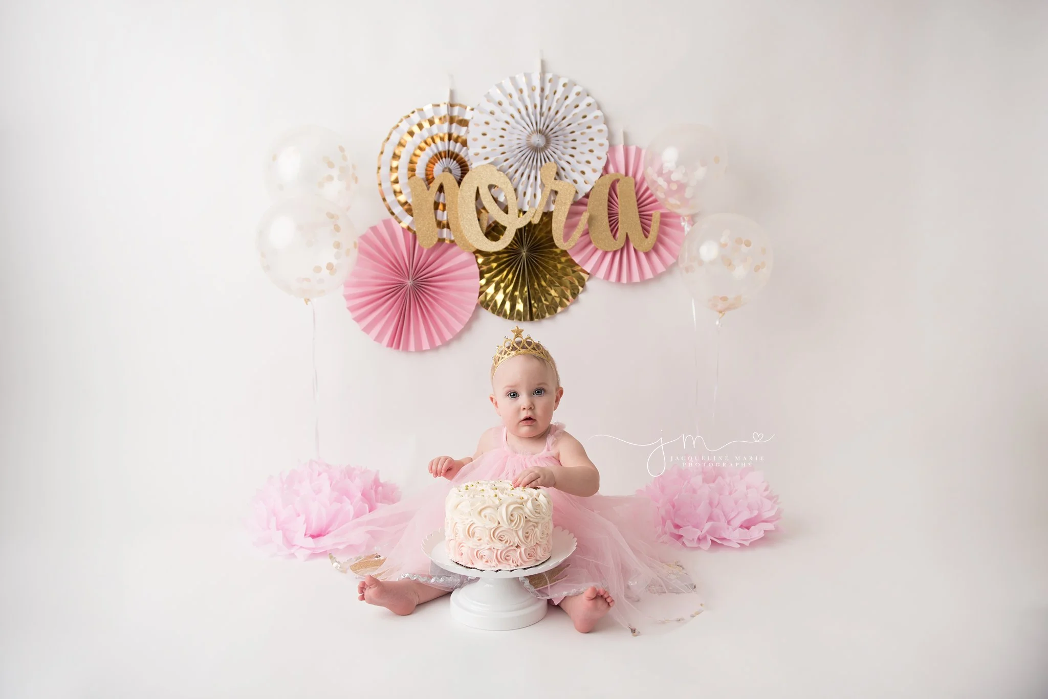 columbus ohio cake smash photographer features pink and gold setup with balloons