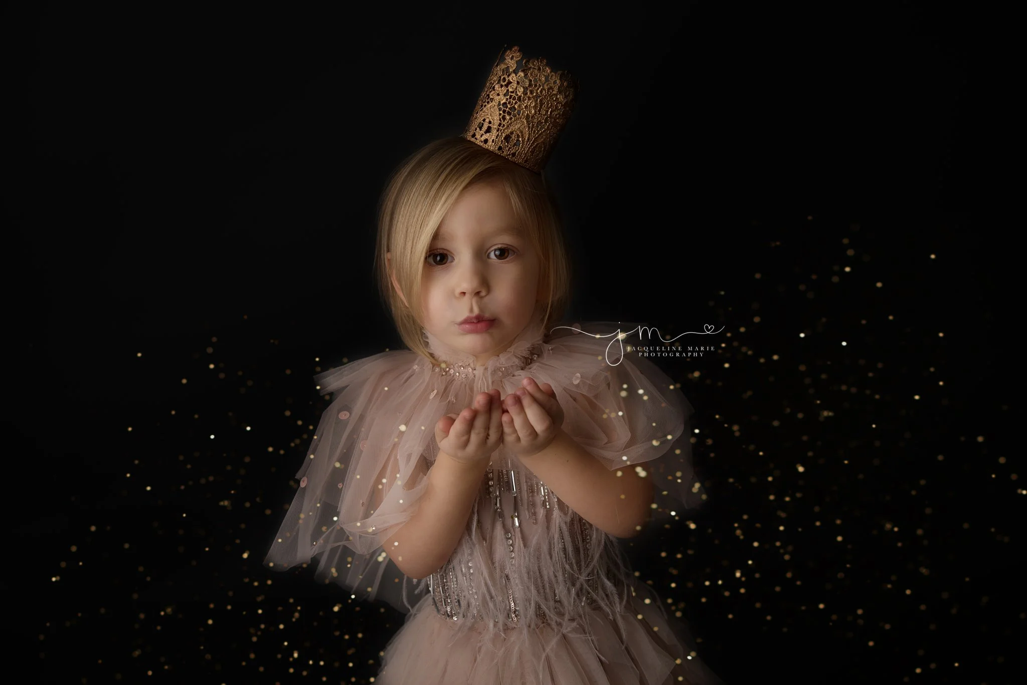 columbus ohio children photographer features image of three year old blowing gold glitter wearing pink dress for glitter mini photography session, glitter session with tutu du mode dresses