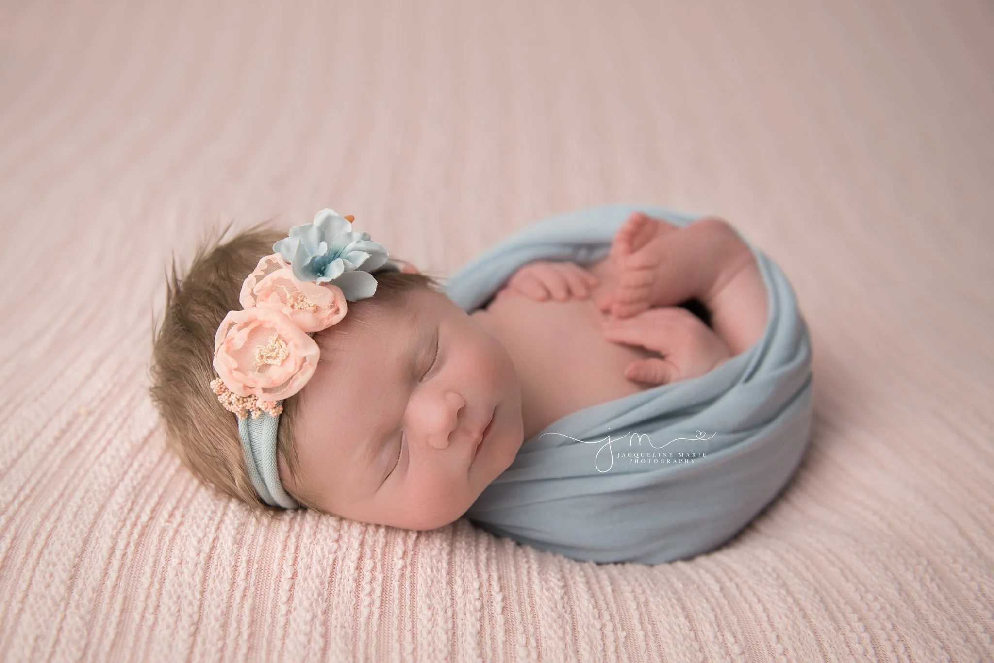 newborn baby girl wrapepd in blue wrap with matching headband in columbus ohio newborn photography studio