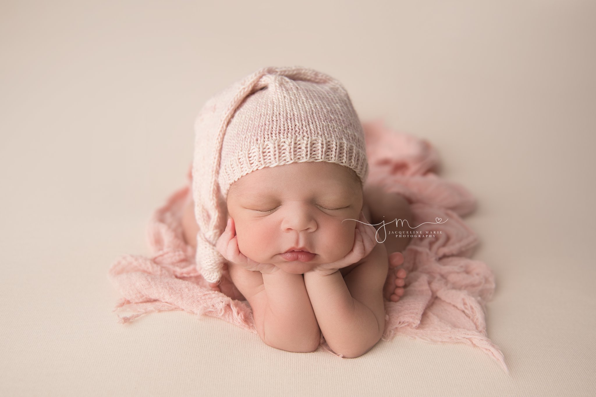 columbus ohio newborn baby girl wears pink sleepy hat for froggy pose during newborn photography session