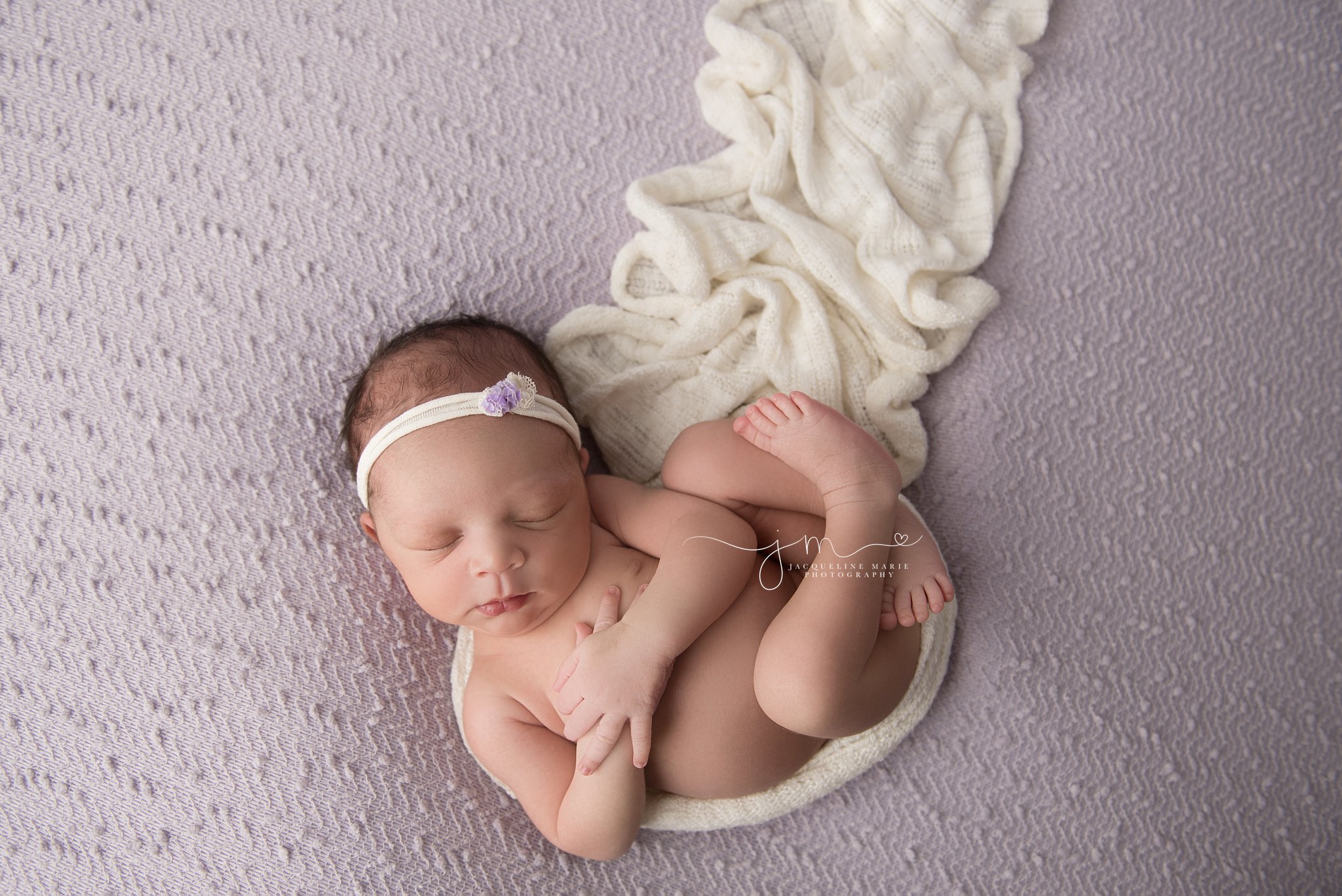 columbus ohio newborn photographer features images of newborn baby girl wrapped in cream knit wrap on lavendar blanket for newborn photo session