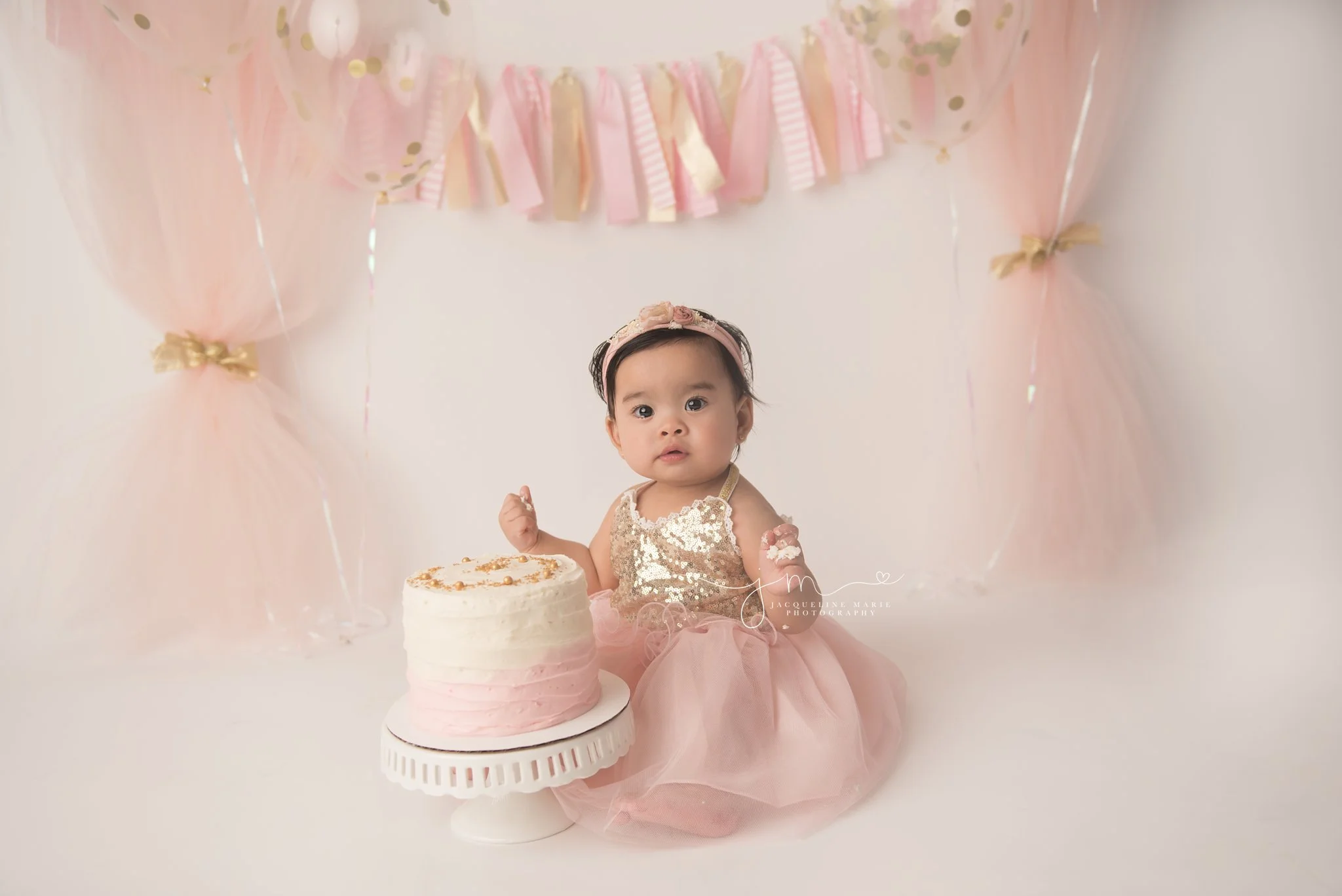 pink and gold cake smash session with balloons and confetti in columbus ohio