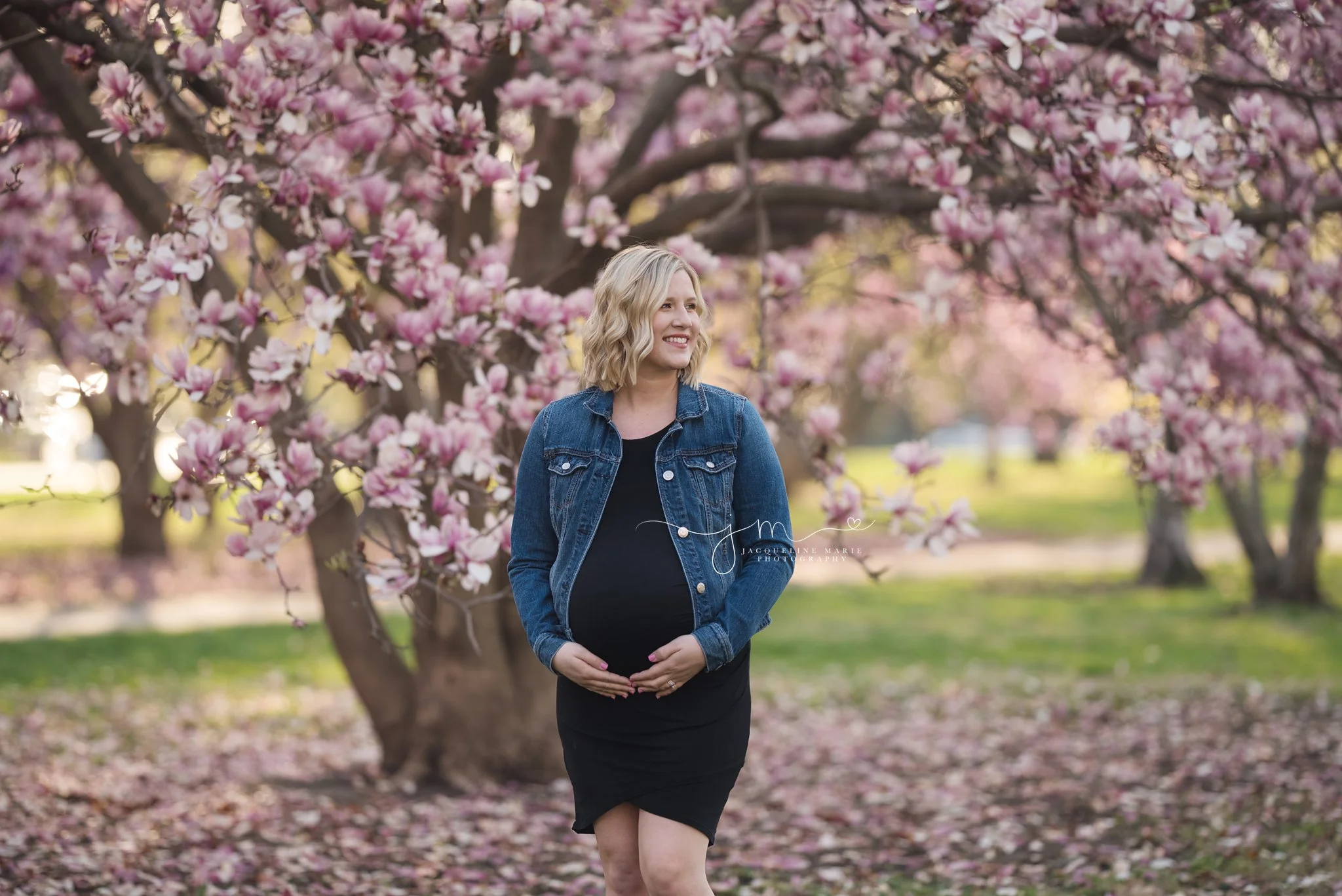 columbus ohio maternity photographer features image of mother to be smiling and holding her belly at goodale park