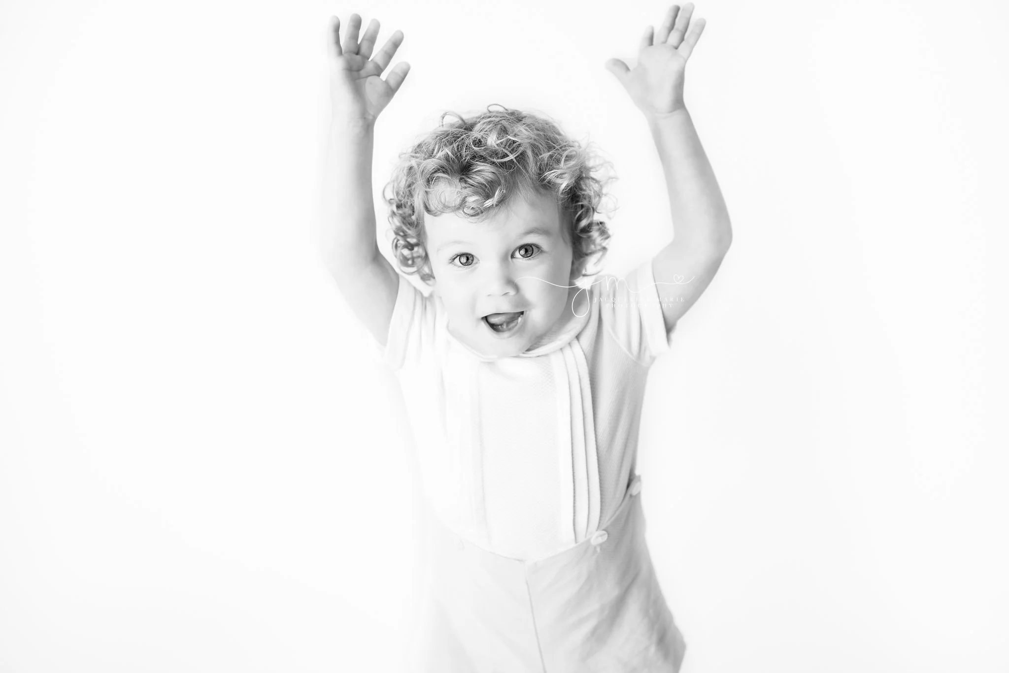 black and white images captures smiles from 2 year old boy in columbus ohio