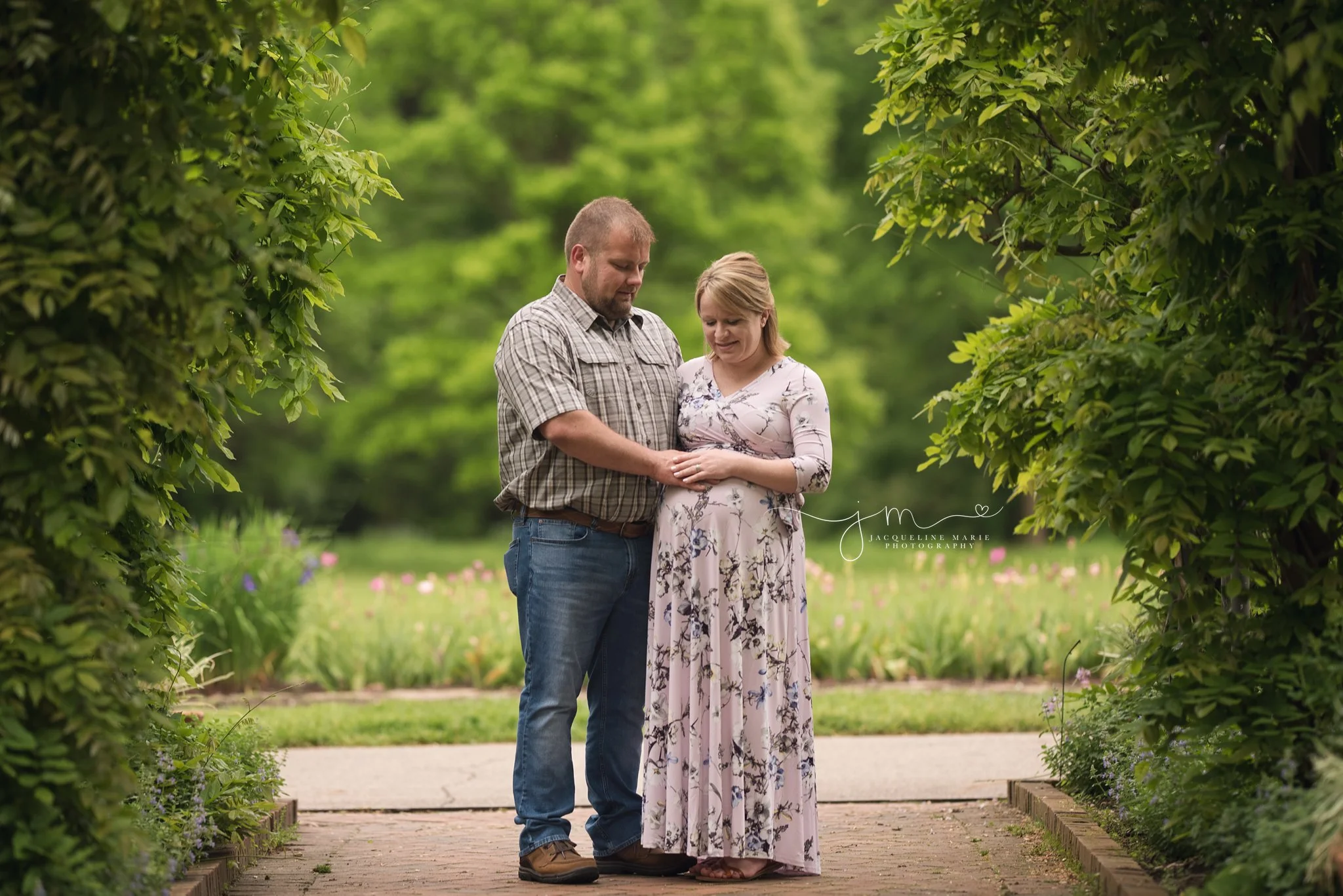 mother and father to be place hands on baby belly during outside maternity photography session columbus ohio
