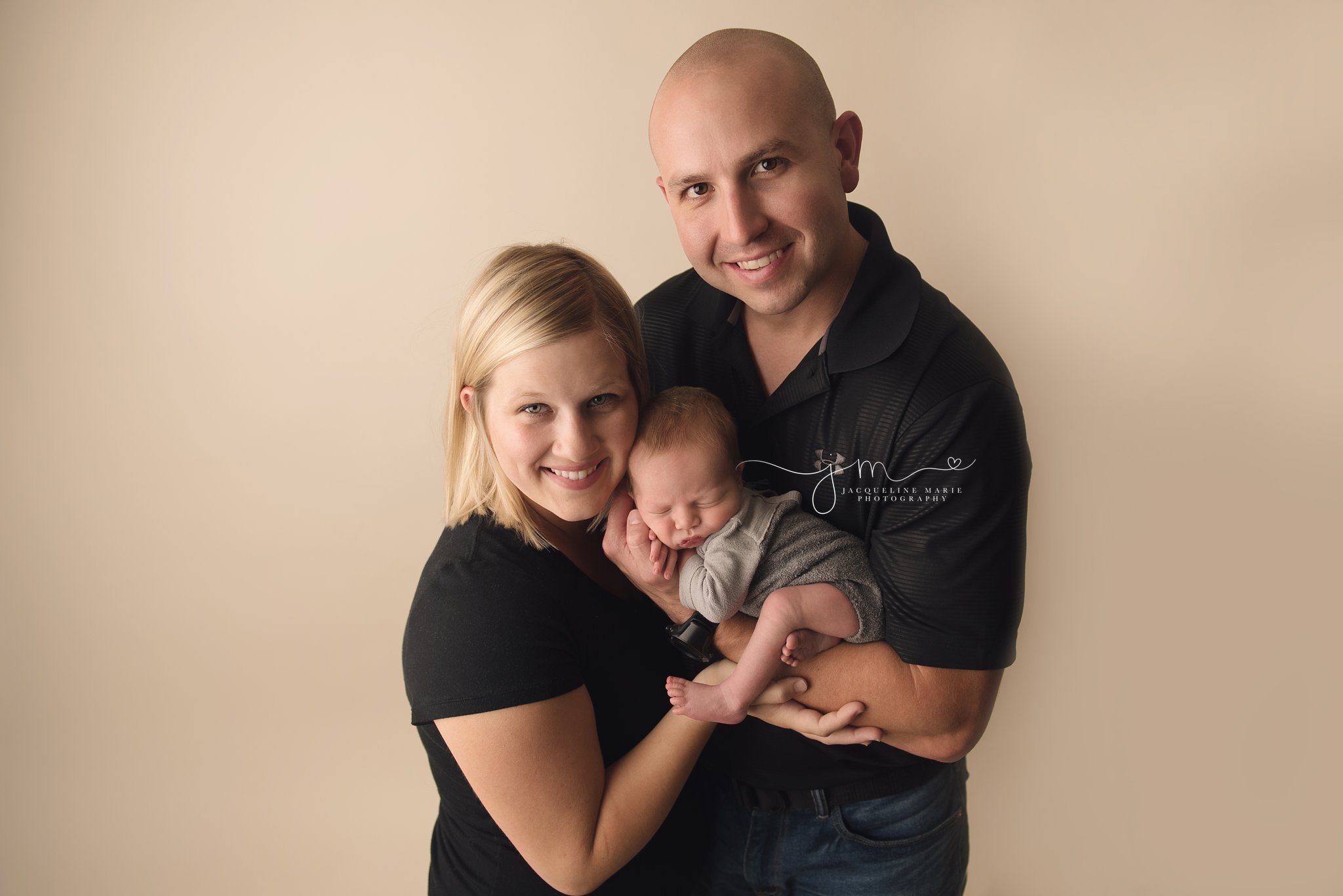 mother and father hold newborn baby boy during newborn session in columbus ohio