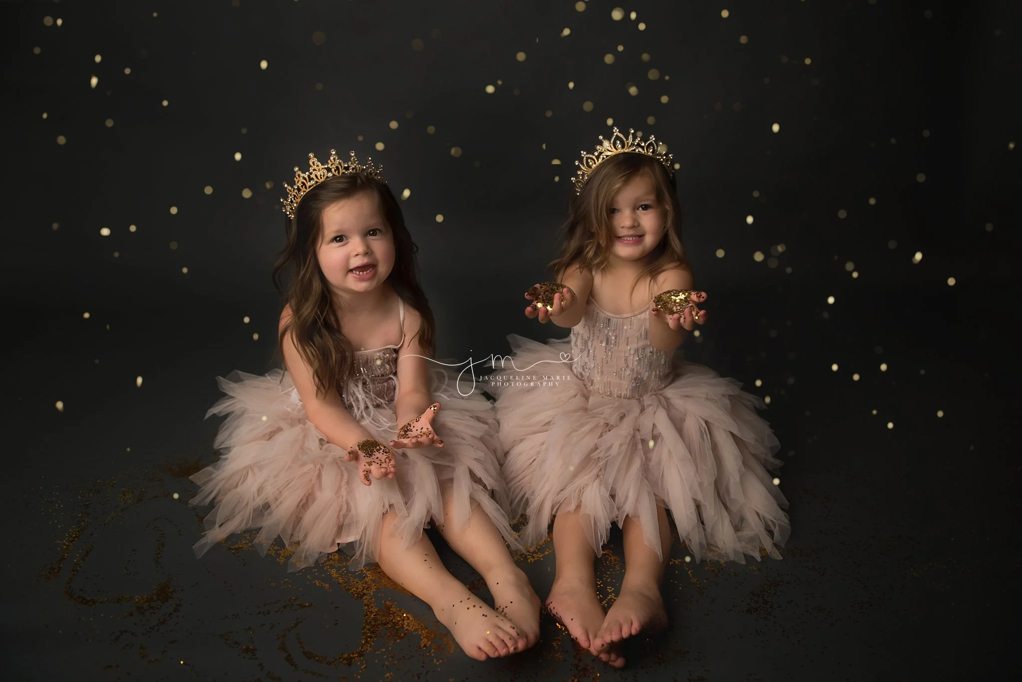 glitter photography for twin sisters wearing crowns and playing with gold glitter in columbus ohio