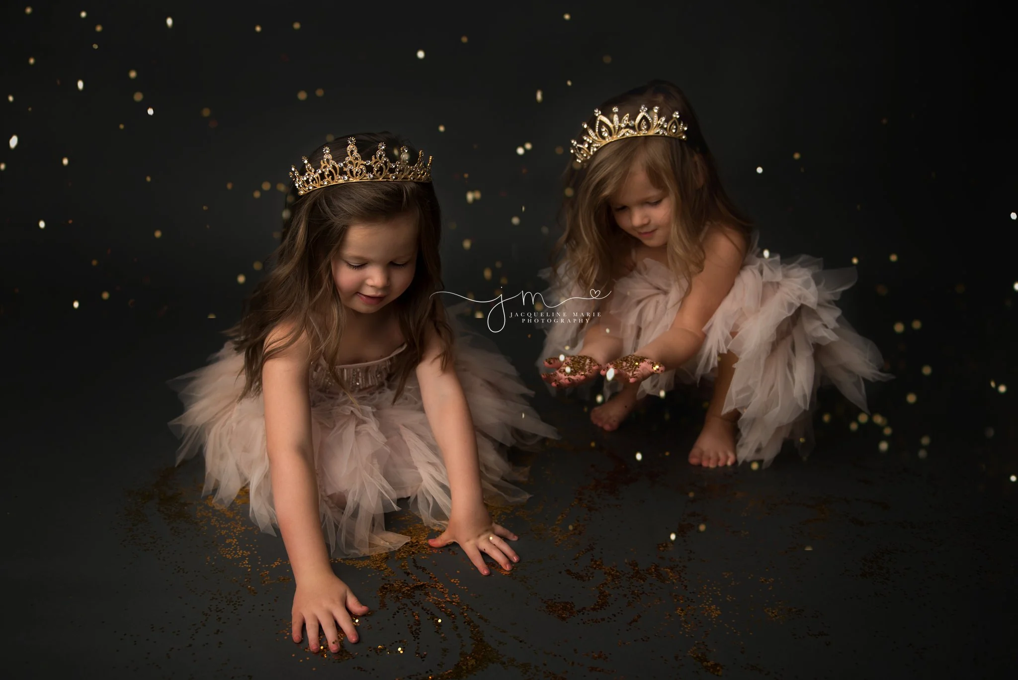 twin sisters play with gold glitter during glitter princess photo session in columbus ohio