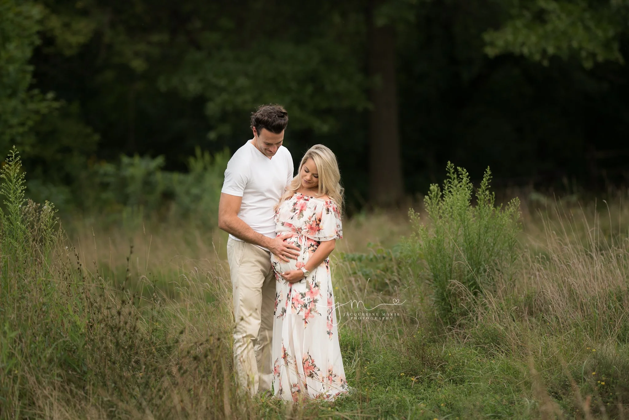 maternity photo session in Columbus ohio during sunset and mother wears floral gown