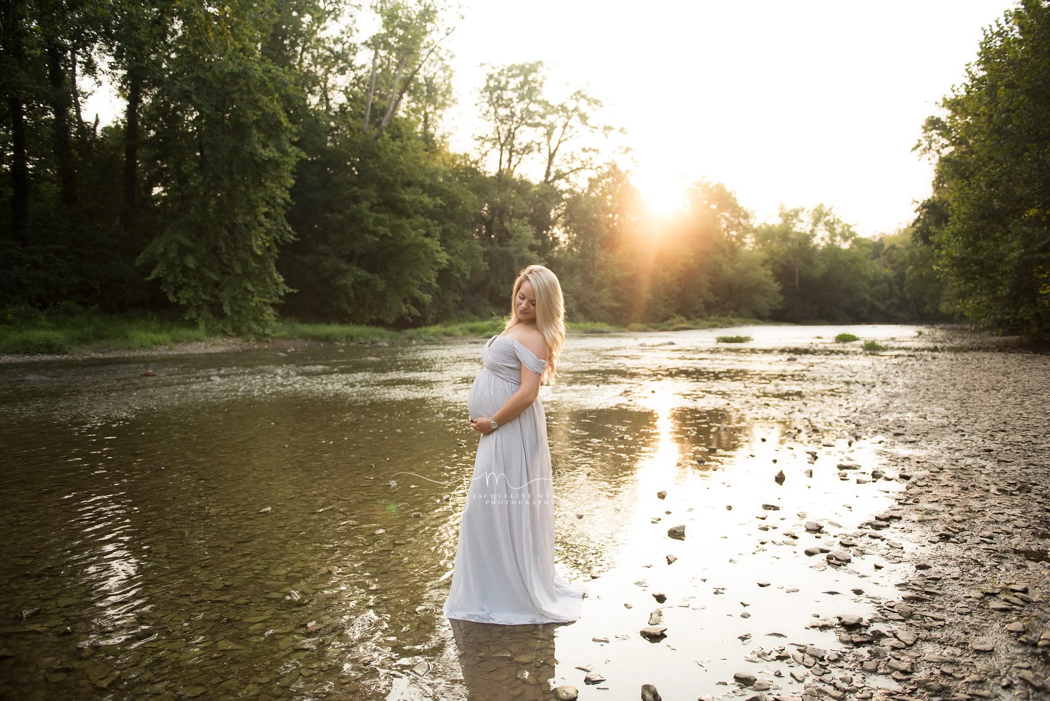 columbus ohio maternity session during golden hour sunset at metro park with water and rocks
