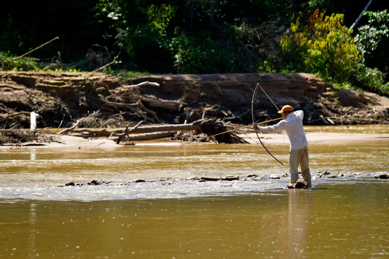 Native boatman hunting Sabalo during lunch break