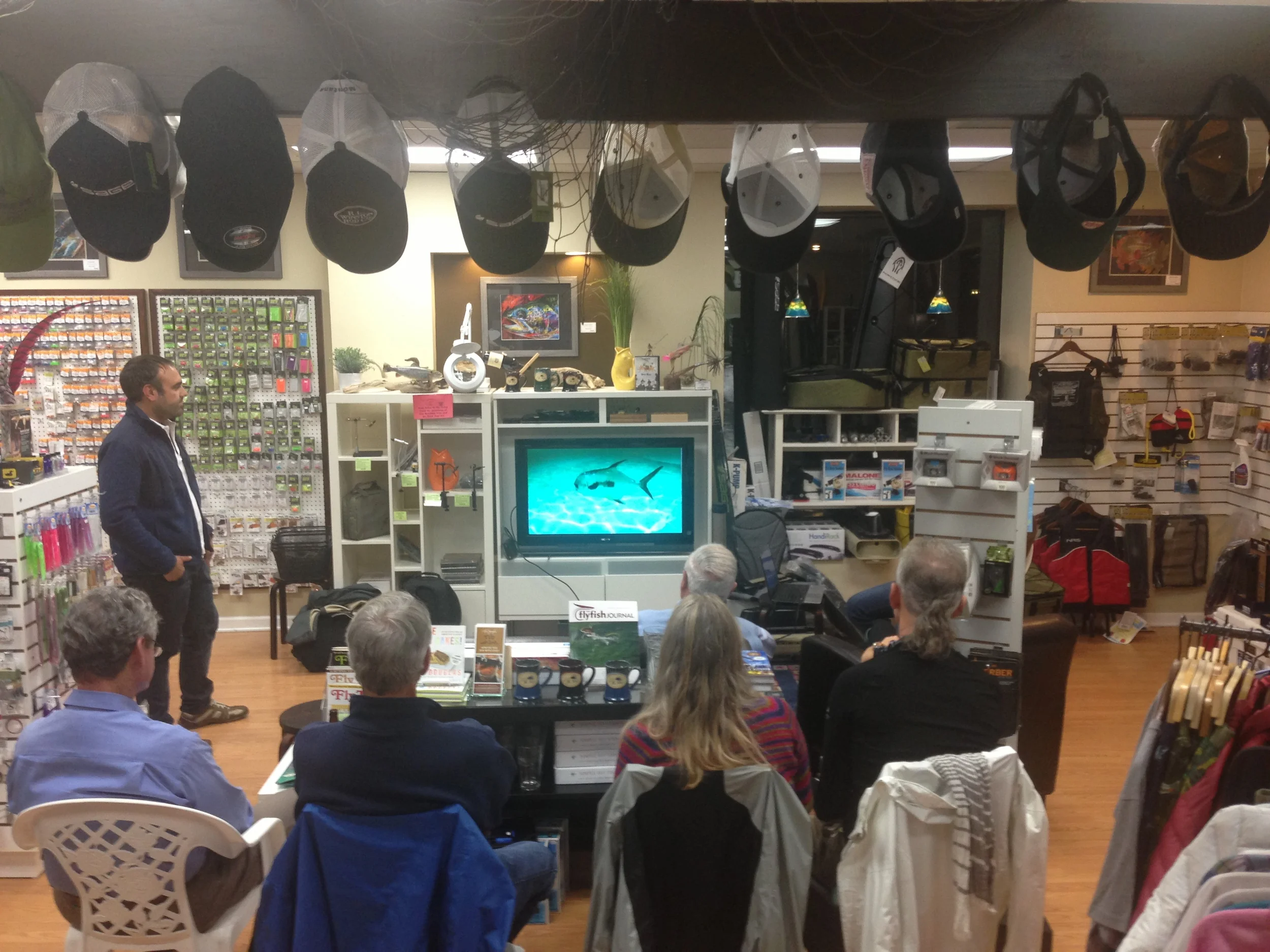 Matias explains the Permit fishing in Cayo Largo at a local shop.