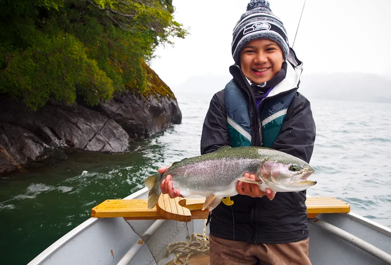  Greger lands a tough Rainbow midging along the edges of the cliffs on the lake.