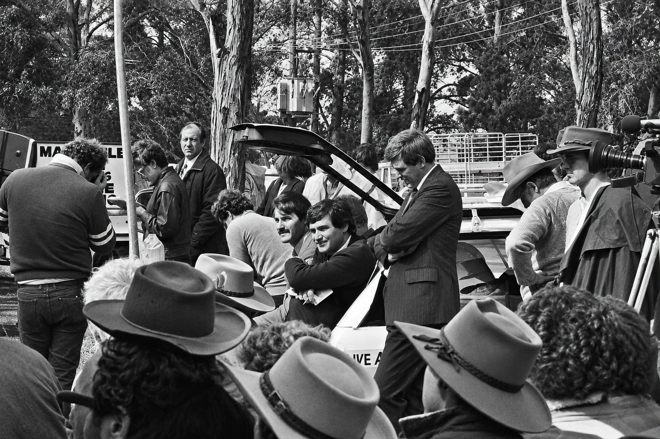 Media and Protest - A television camera records the gathering as people cluster around a vehicle and speakers. The photograph captures the growing media attention surrounding the cattlemen's protest and the meeting between rural Australia and the cit