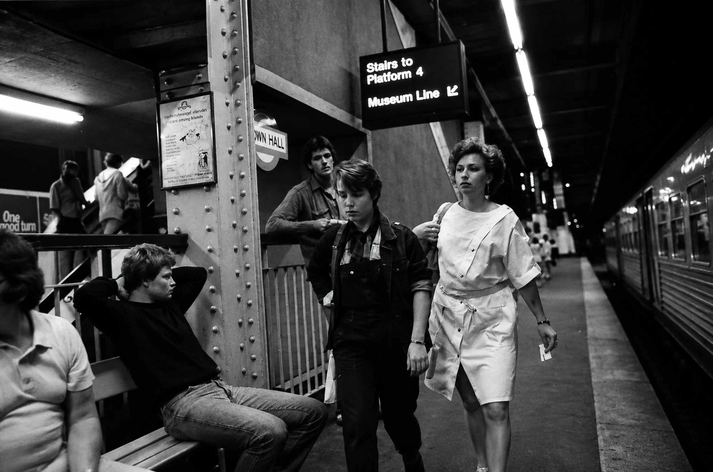 Platform Movement - Passengers wait and walk beside the train as others descend the stairs. The photograph captures the constantly changing mixture of people that passed through Sydney's underground stations every day.