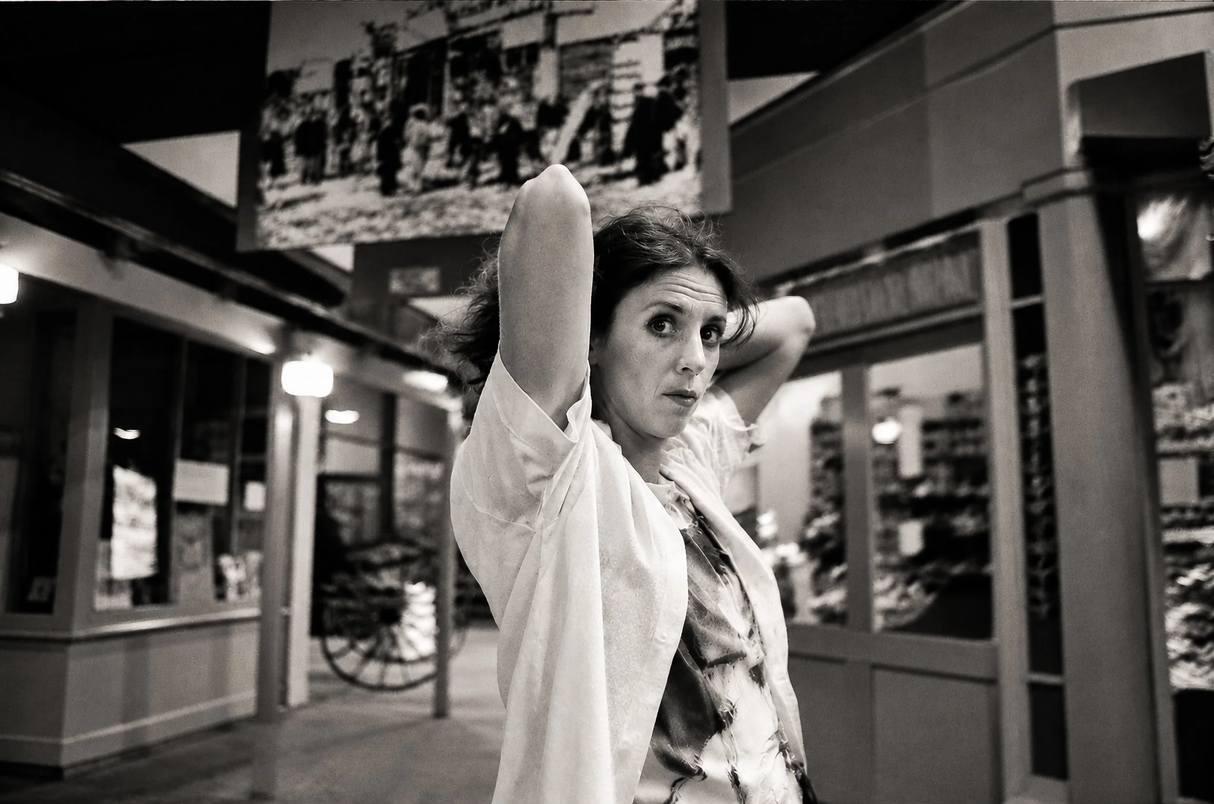 Passing Through - A woman adjusts her hair as she moves through the station, apparently unaware of the camera. The moment is brief and ordinary, making it a particularly natural example of the candid approach behind the collection.