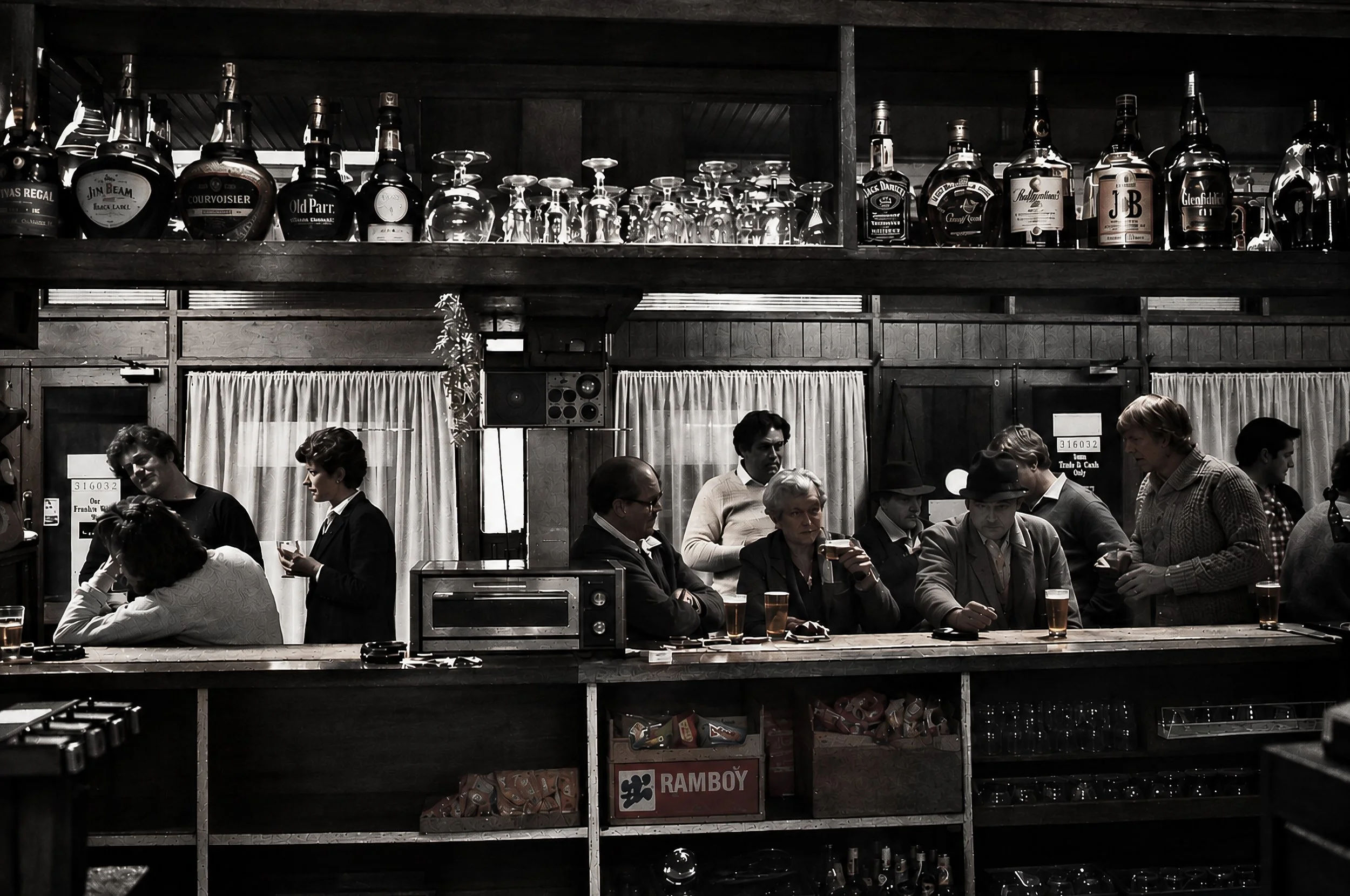 Inside the Country Pub - The bar of an Australian country pub comes alive with conversation. Patrons gather around the timber bar beneath shelves of bottles and glasses, creating an evocative portrait of the social heart of a rural community in the 1