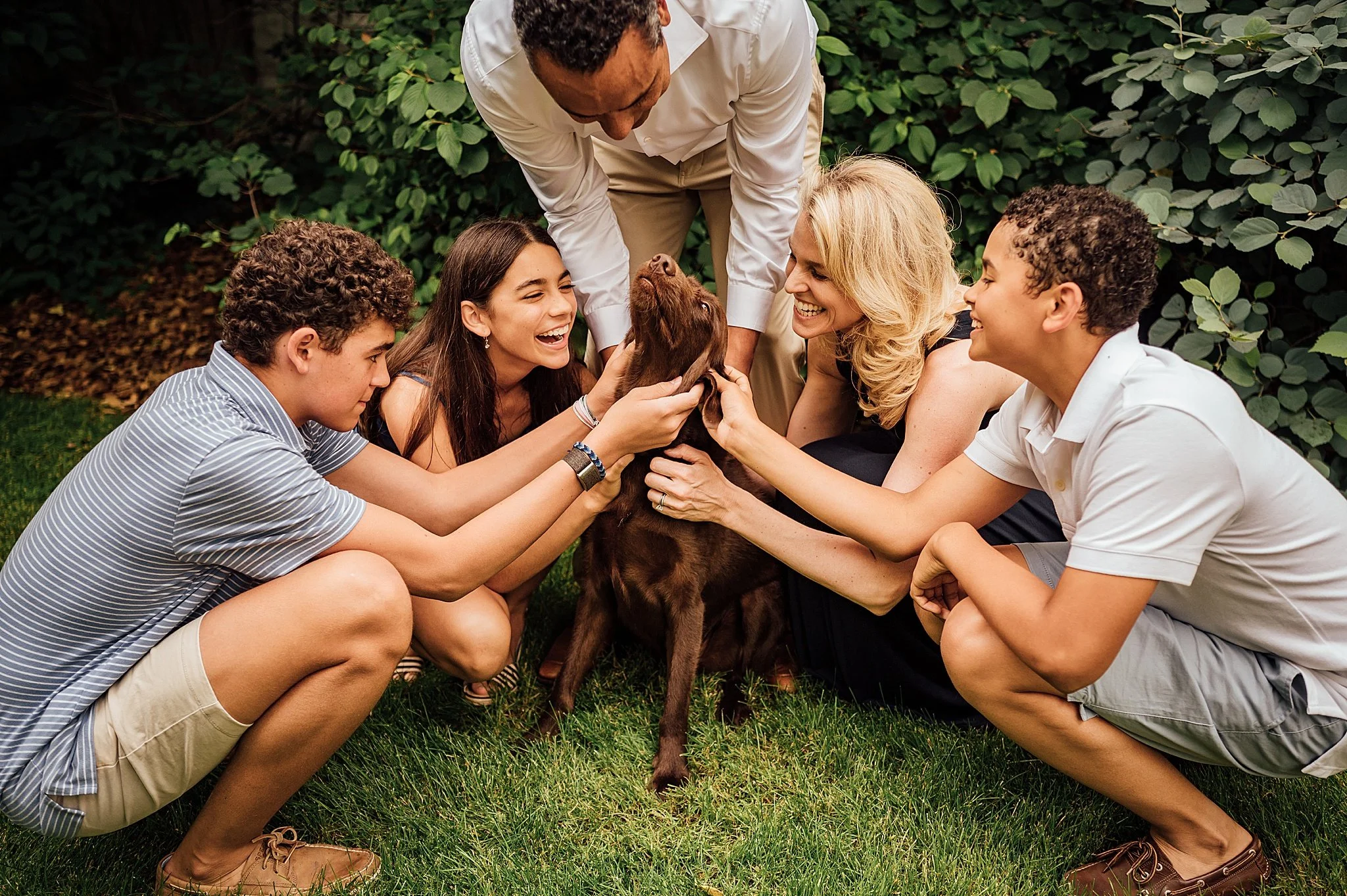 The whole family loving on the family dog