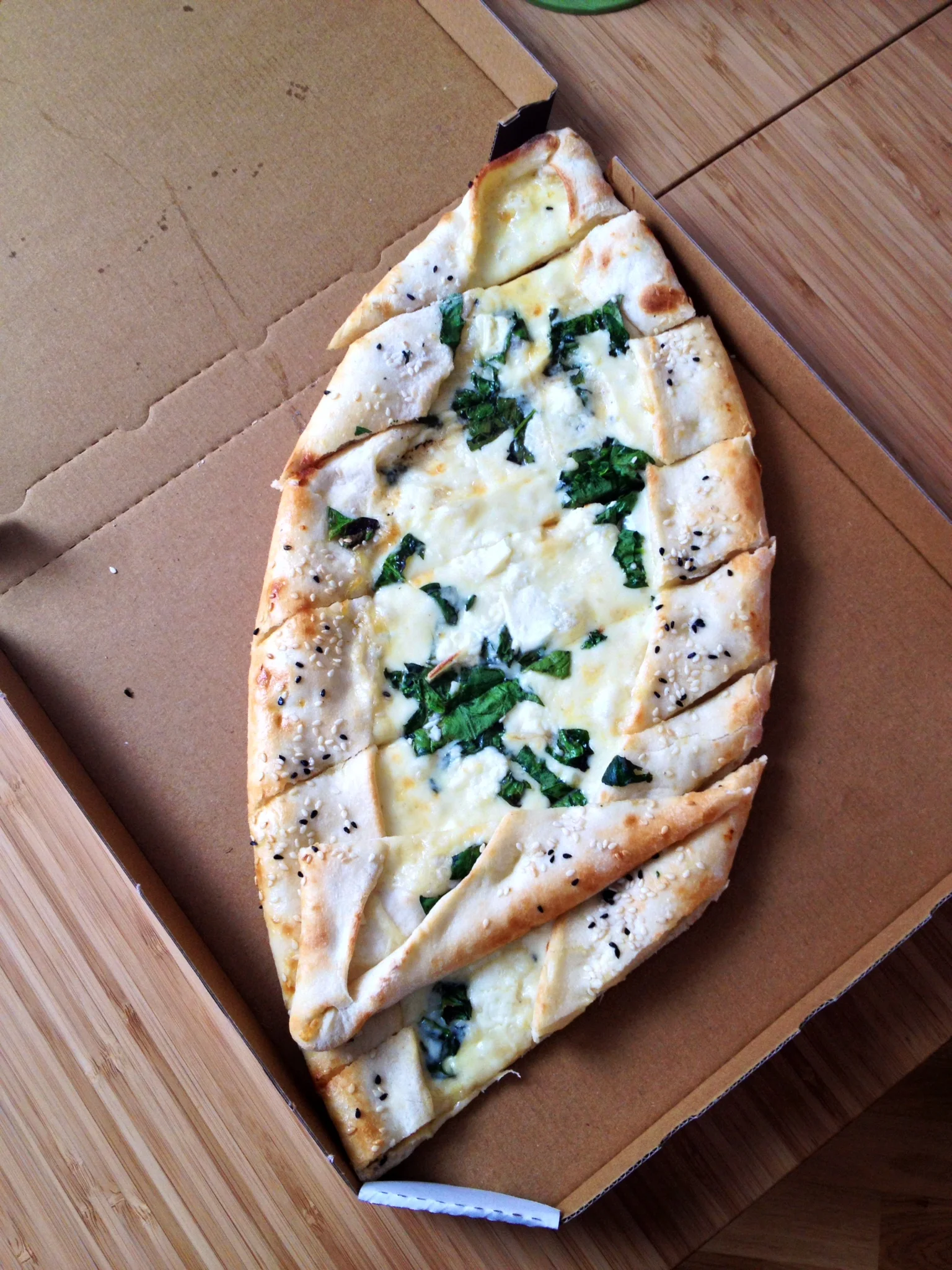 Pide with spinach, cheese, and egg. 
