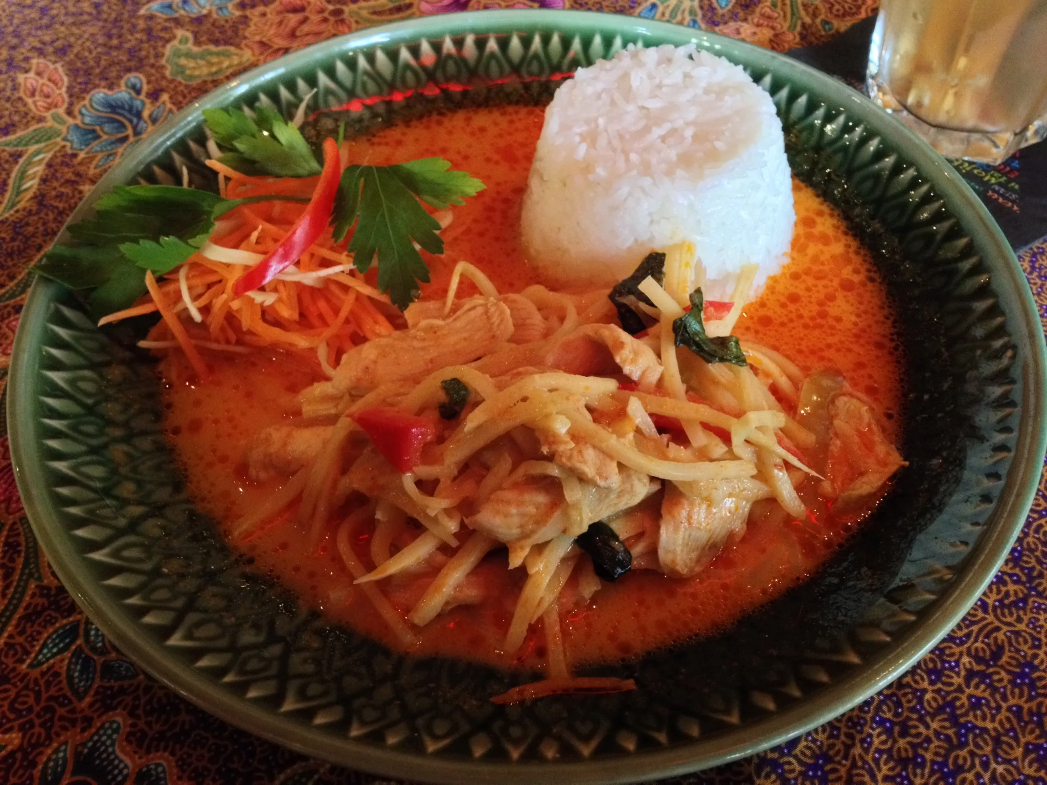 Gäng Ped Gai (chicken in red curry sauce with coconut milk, bamboo shoots, and Thai basil)