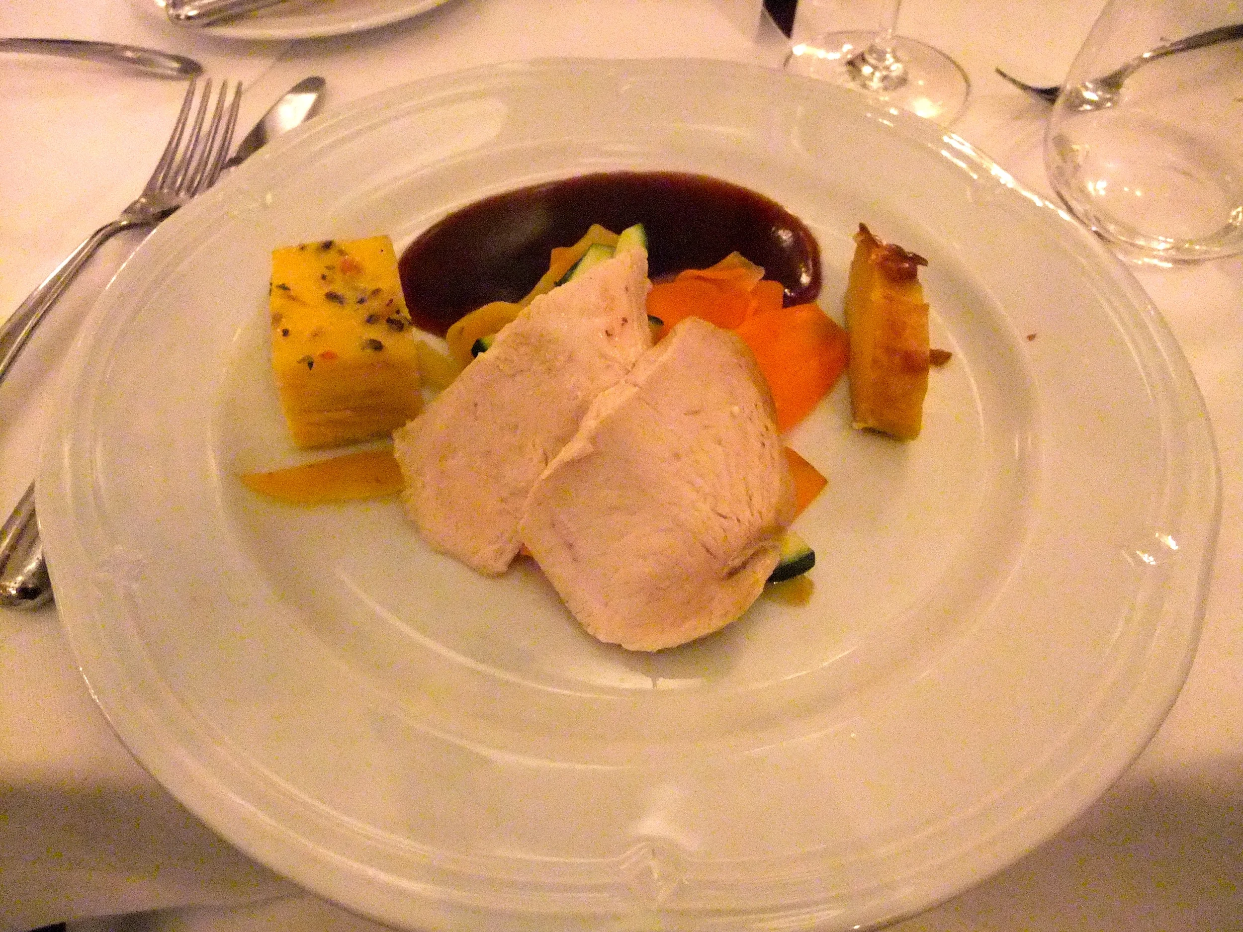 Breast of capon on glaze of red wine and herbs with potato gratin, semolina strudel, and vegetables from Padre Prior's garden