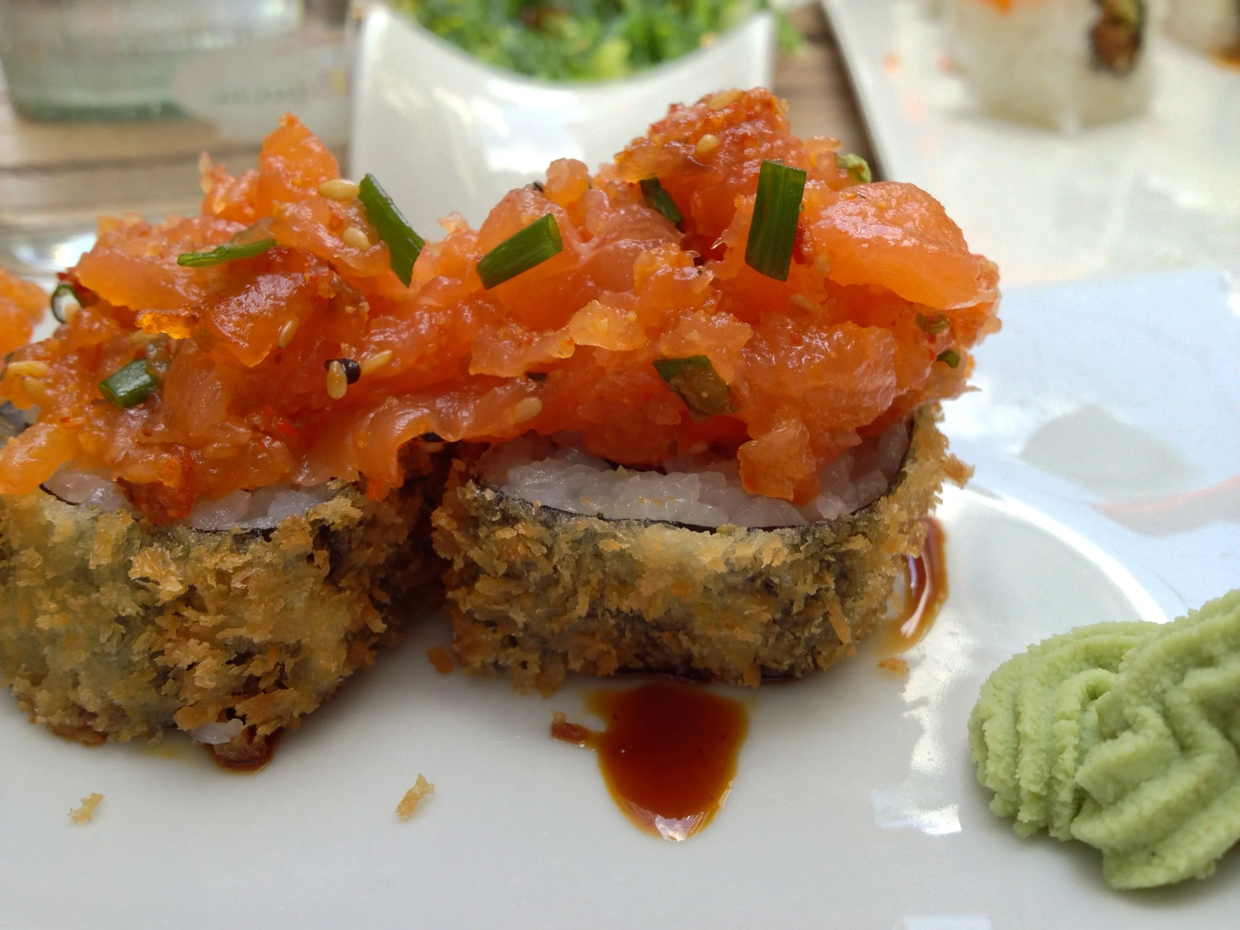 Fried avocado roll topped with spicy salmon at QQ Sushi Lounge