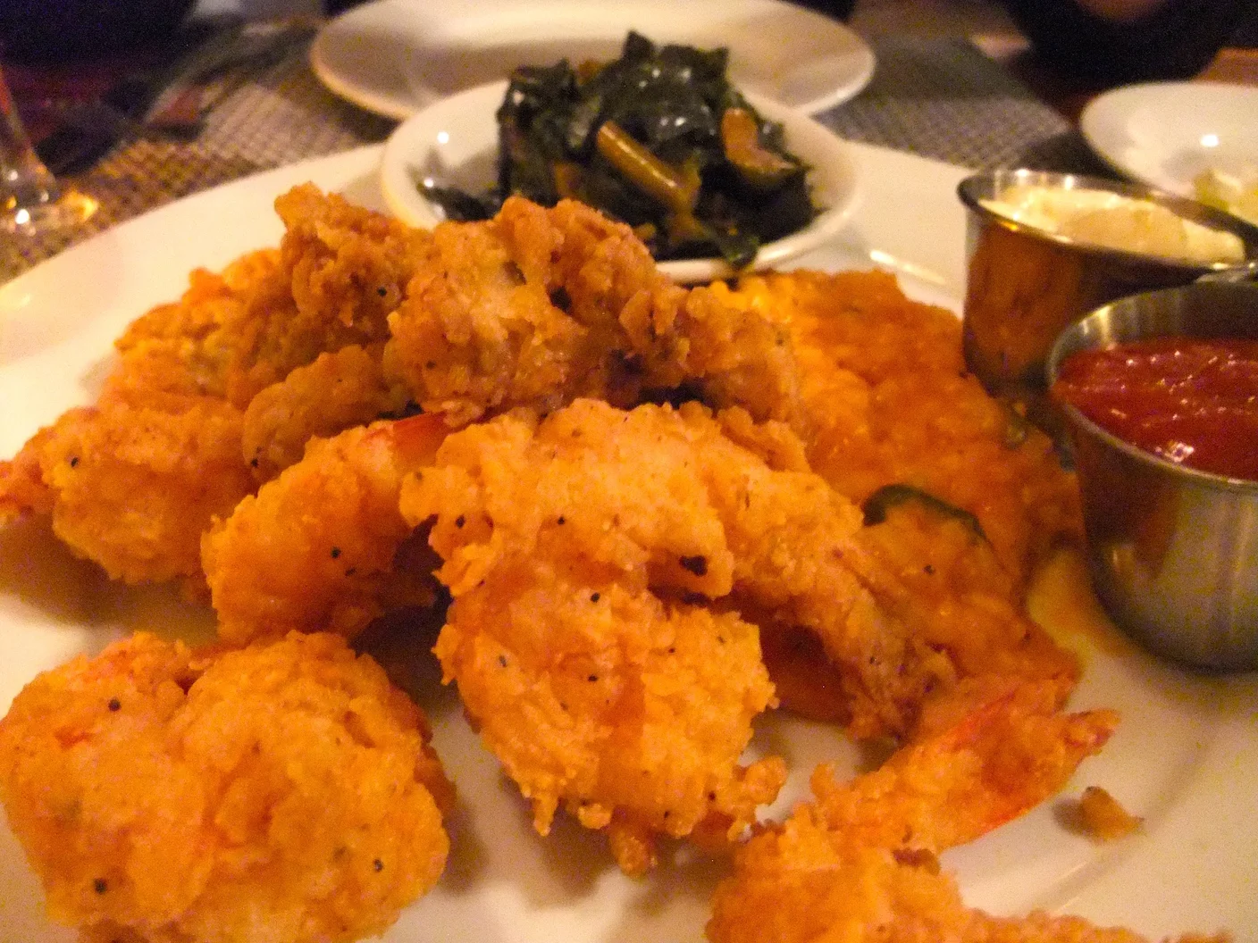 Calabash-style fried shrimp and oysters with red rice risotto and collard greens at Poogan's Porch (Charleston, SC, USA)