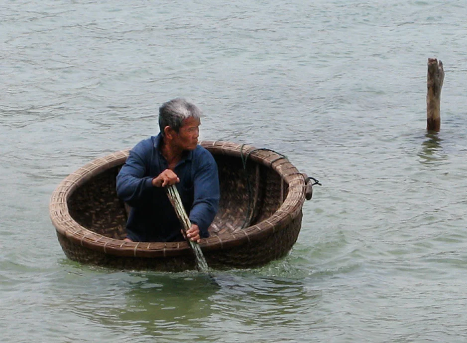 80 years old in straw boat, Hon Tre Island, Vietnam