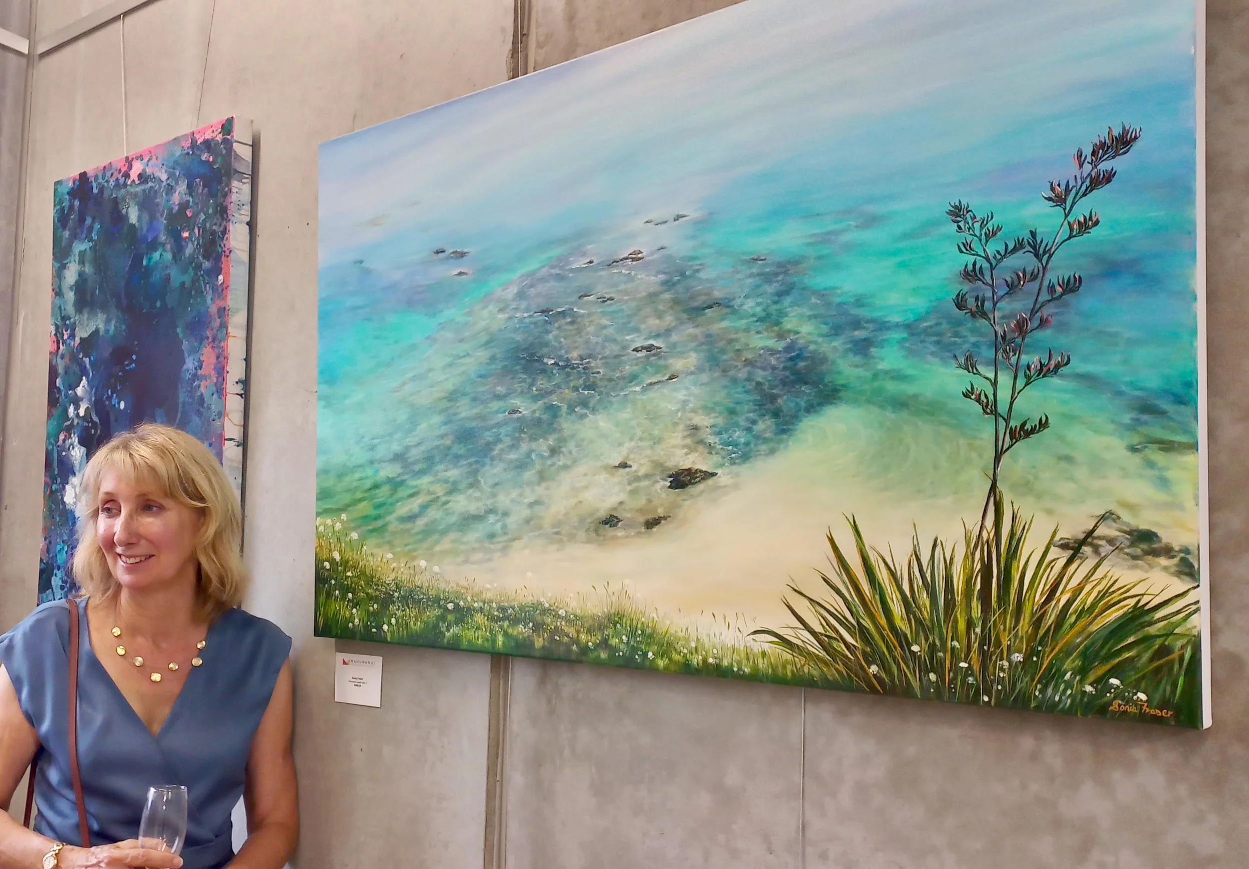 Sonia Fraser New Zealand Artist standing in front of her painting Whananaki Coastal Walk VI