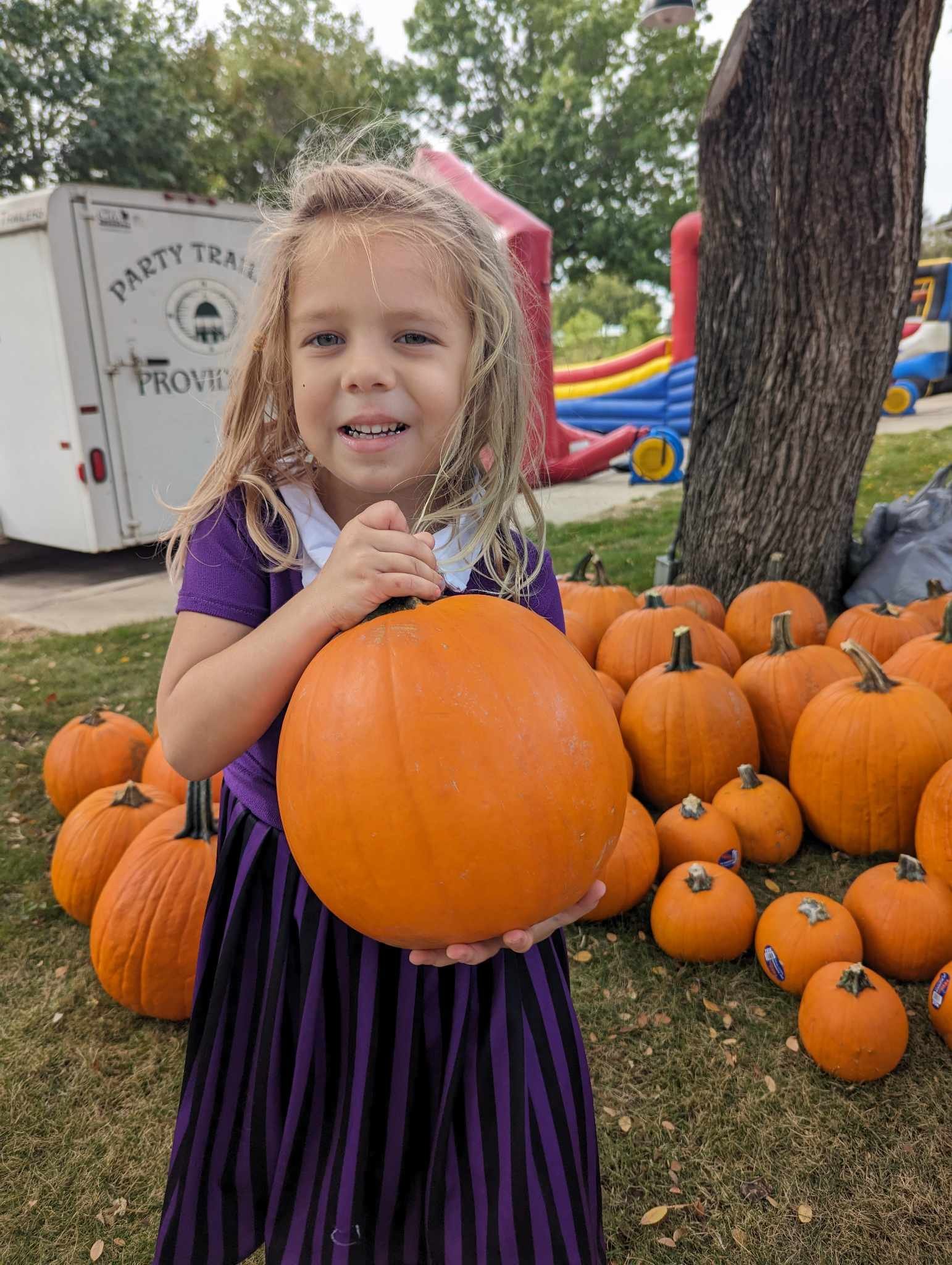 Girl and her chosen pumpkin.jpg