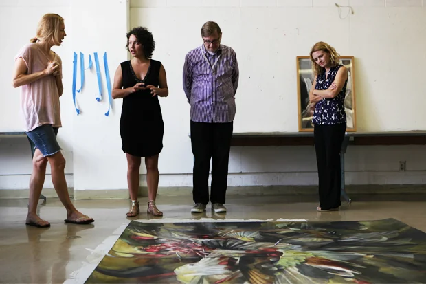 Artist Emily McIlroy, assistant curator of arts of Hawai‘i Healoha Johnston, Jensen, and Love take in McIlroy’s ‘Sky Burial’