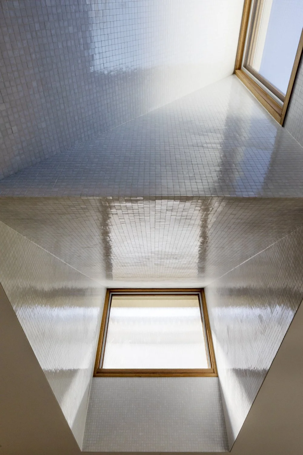 Melbourne interior designer Meredith Lee selected Bisazze glass mosaic tiles for the roof windows.