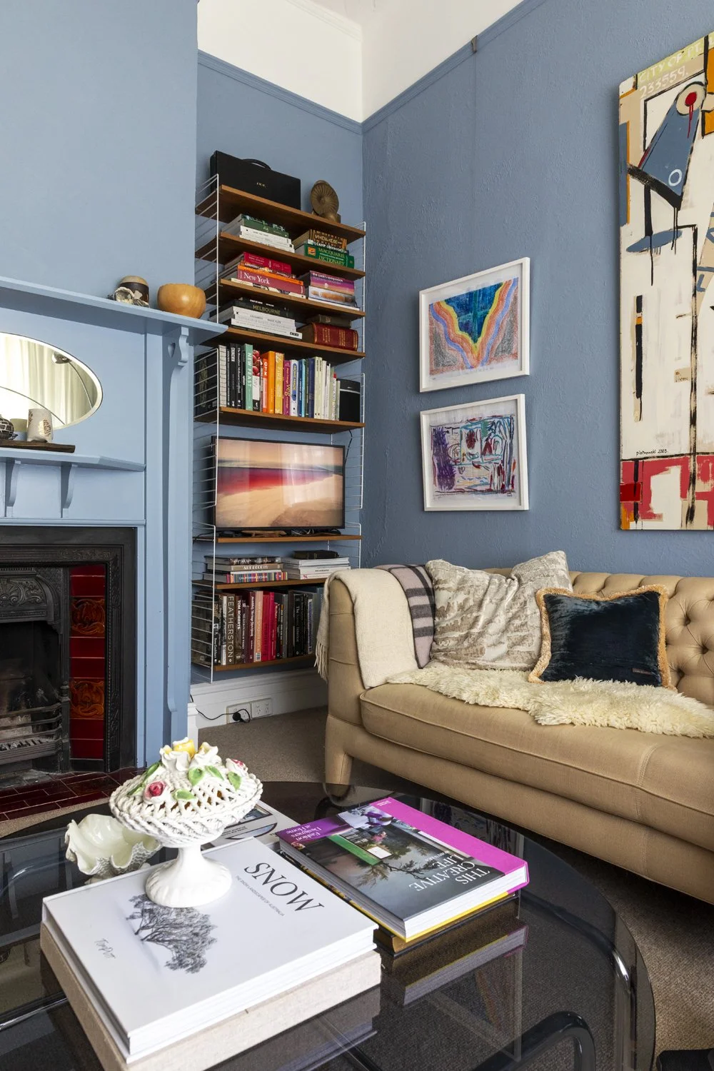Blue painted sitting room with traditional fireplace by Melbourne interior designers Meredith Lee