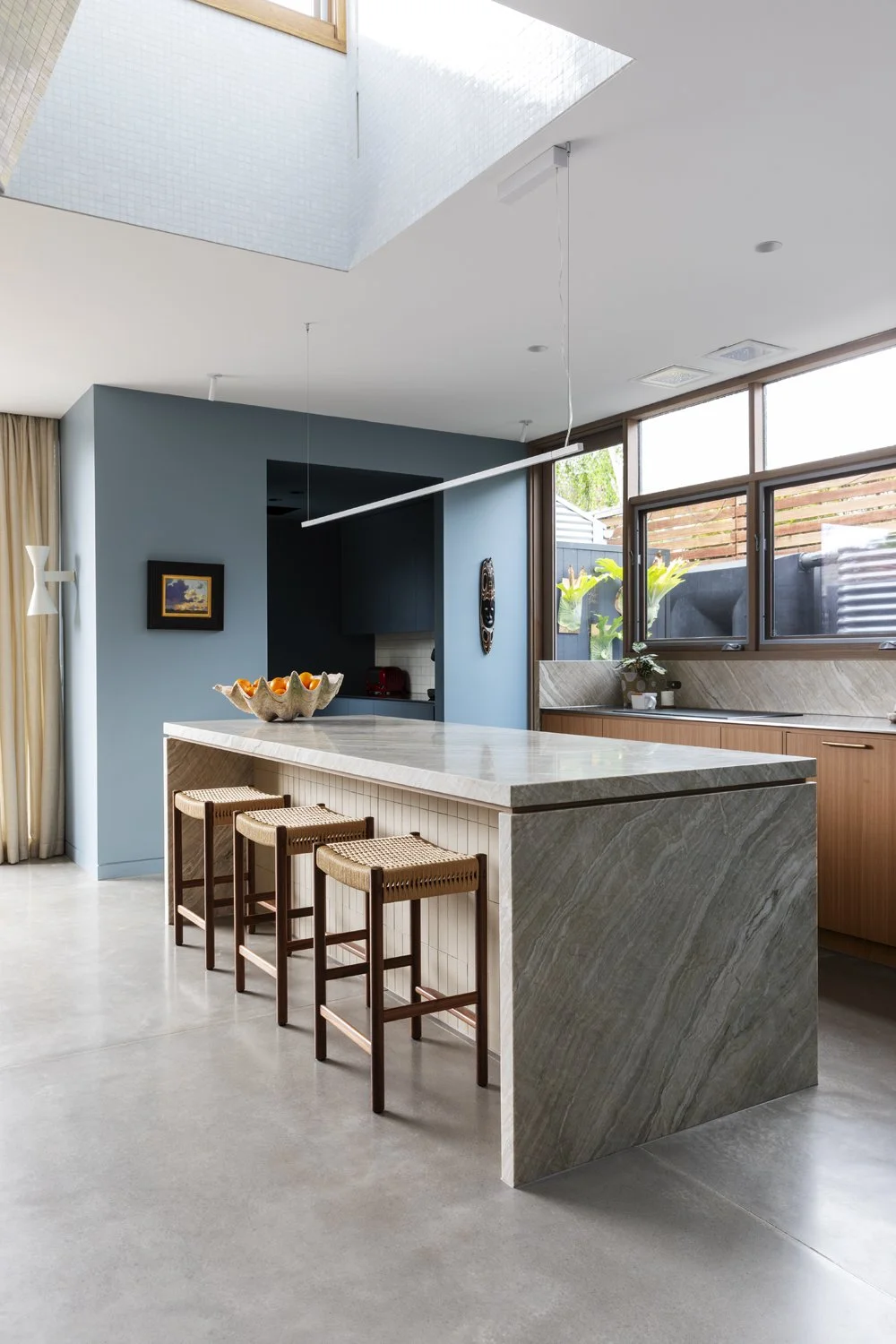 Melbourne interior designers Meredith Lee used wall colour to highlight art and quartzite in the family kitchen.