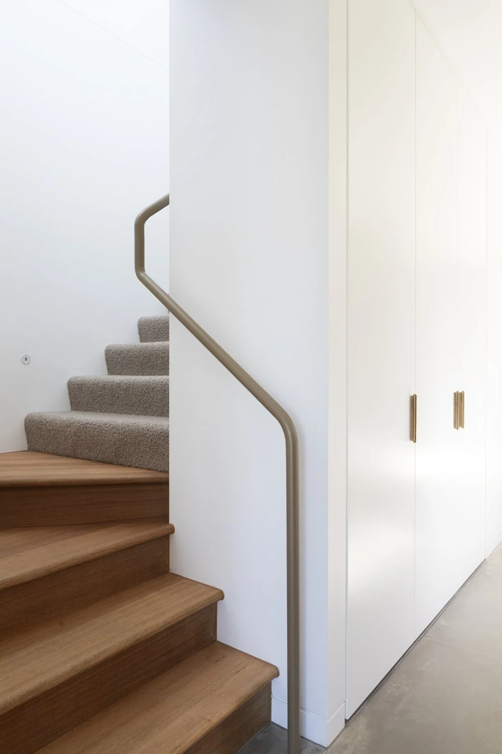 Melbourne interior designers Meredith Lee designed a custom made hand rail for this timber stair well.
