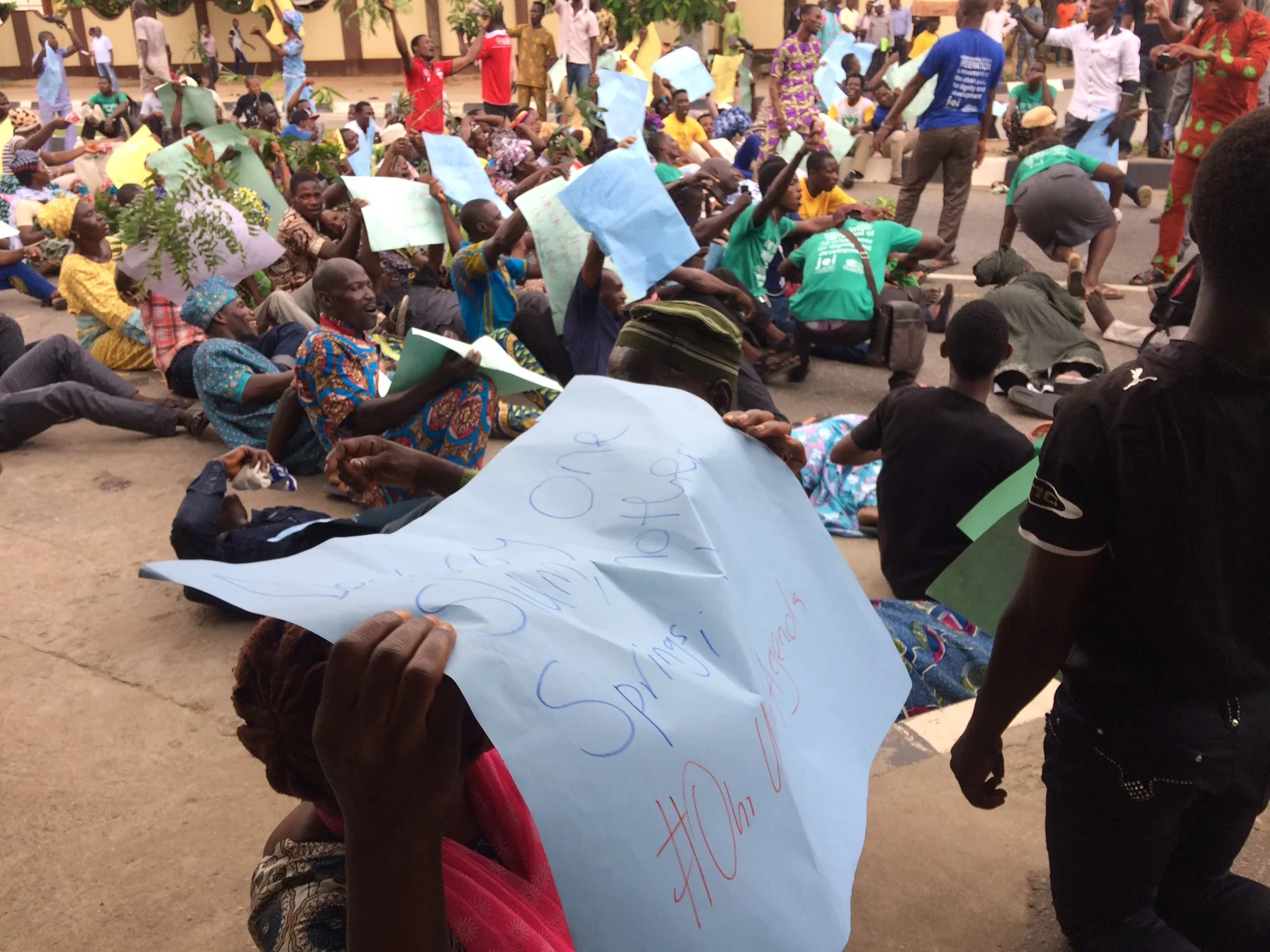 Lagos federation protests threatened eviction of dozens of waterfronts in Lagos. On day 1 of protests, 13 October 2016, protesters lie in the street to demonstrate how the threatened evictions will cause loss of lives, shelter, and livelihoods. One sign reads "destroy one slum, another springs up. #oururbanagenda."