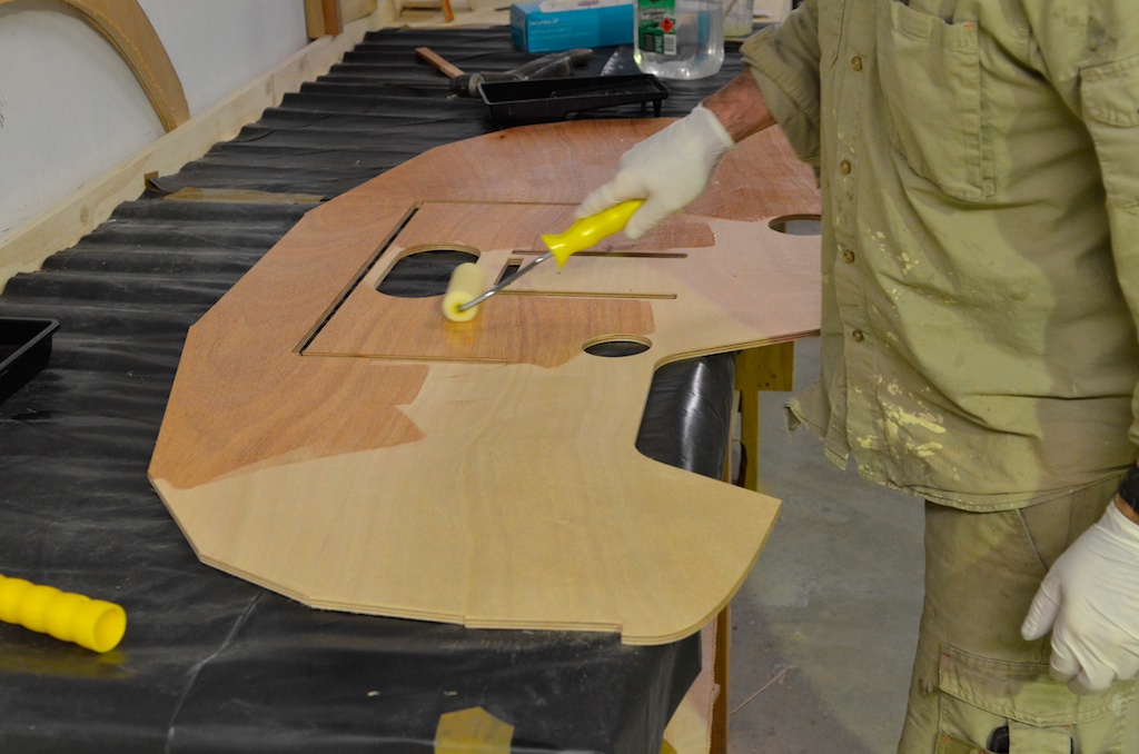 Sealing the face of the inner layer of the transom, the thin slots are mortices for frames and must be kept clear of thickened glue , also visible are cutouts for the motor, boomkin, sculling notch and tiller
