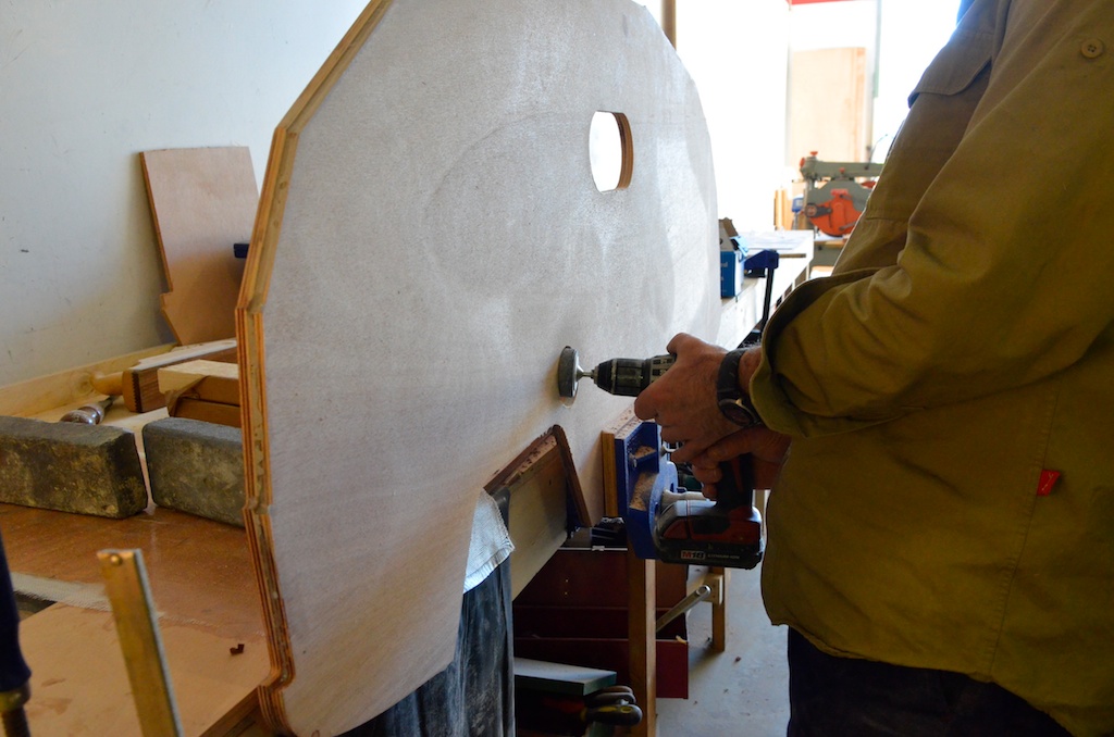 Sanding the boomkin hole. The two layers are slightly different sizes which gives a stepped outer edge which gives the bevel for planking.