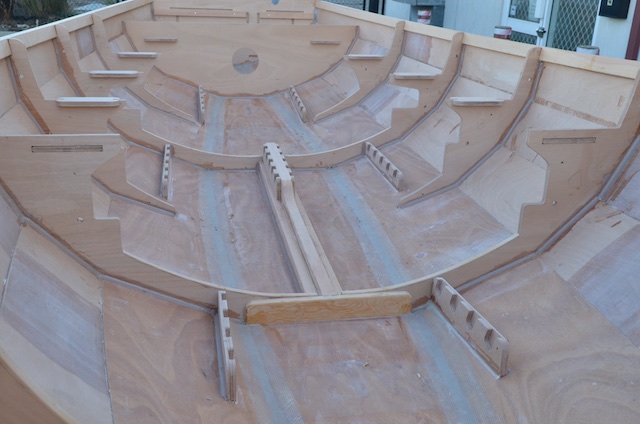 Interior shot showing rowing stretcher bearers, the side bearers are fitted as before the outer sheathing is done, the two central bearers are on a plank where the centreboard would be in a sailing version.