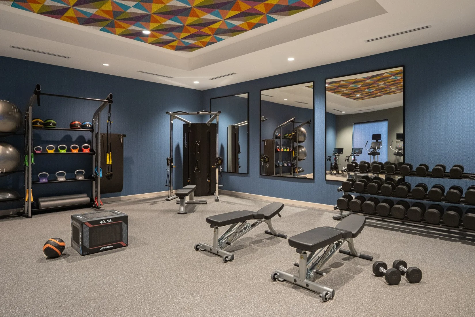  Original Filename: BNALIHT_Home2_fitnessweights_4919.jpg File Name: fitness_weights Caption: Fitness center weights Marketing Caption: Strength training equipment available in the fitness center. Alternate Tag: Fitness center with free weights and s