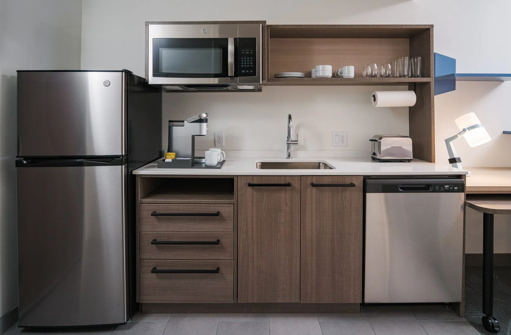  Original Filename: BNALIHT_Home2_roomappliances_4935.jpg File Name: room_appliances Caption: Suite appliances Marketing Caption: In-suite appliances offer convenience during extended stays. Alternate Tag: Microwave and refrigerator appliances in gue