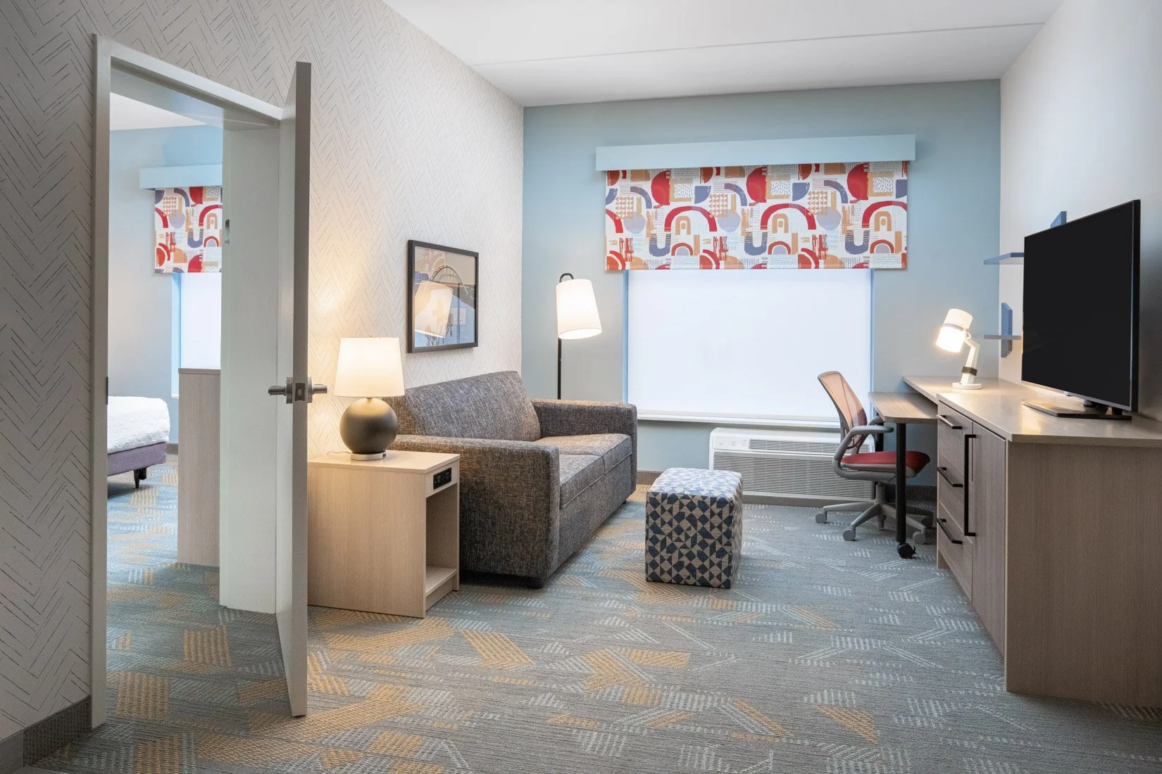  Original Filename: BNALIHT_Home2_qqueenonebed_living_4939.jpg File Name: onebed_queen_living Caption: One bedroom living Marketing Caption: Living room seating area in the one bedroom queen suite. Alternate Tag: Living room with sofa seating in one 