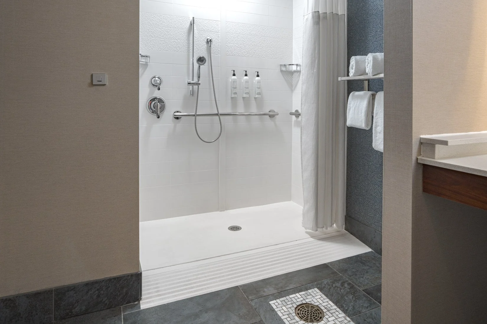  Original Filename: 1716_GTLFG_Fairfield_adarollinshower.jpg File Name: GTLFG-Accessible-Roll-In-Shower.jpg Caption: Accessible bathroom with roll-in shower Marketing Caption: Accessible guest bathroom with roll-in shower and safety features at Fairf
