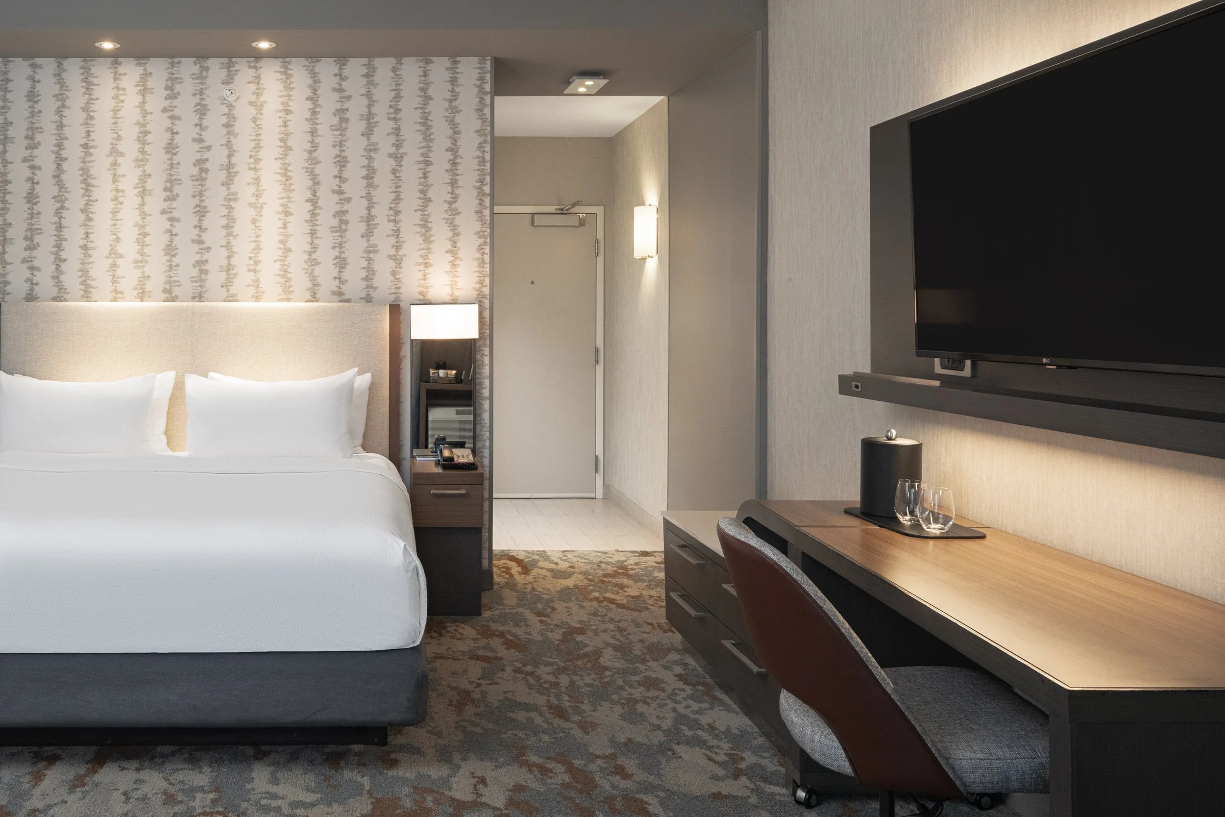  ORIGINAL FILENAME:  4924_TYSCP_Courtyard_omgl_door.jpg  FILE NAME:  Guest Room  PHOTO PLACEMENT TAG:  Search in DAC for: Guest Rooms  CAPTION:  Guest Room – Entry  MARKETING CAPTION:  The entry-side guest room view highlights the bed, mounted televi