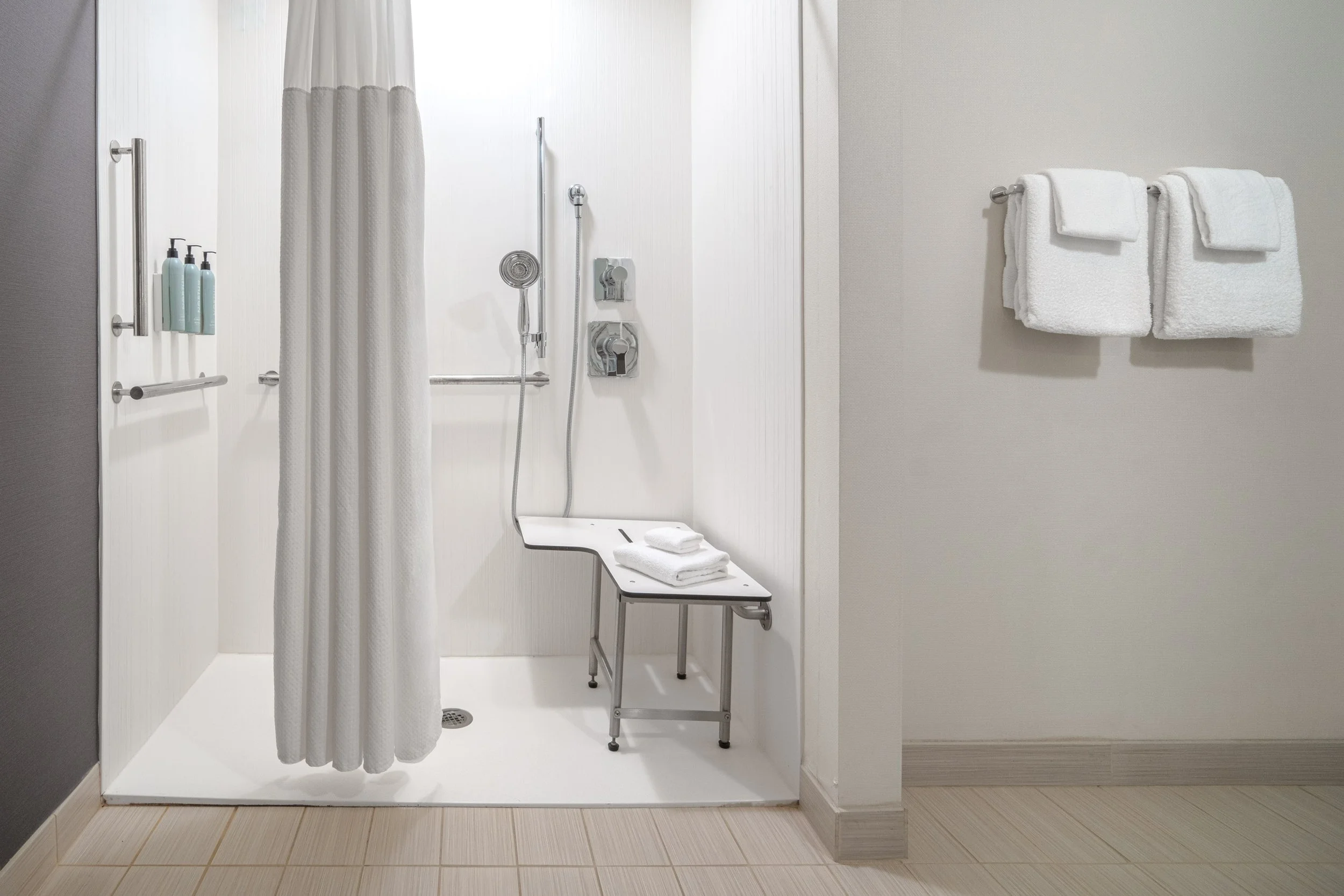  ORIGINAL FILENAME:  4945_TYSCP_Courtyard_room_ada_rollin.jpg  FILE NAME:  Bathroom  PHOTO PLACEMENT TAG:  Search in DAC for: Guest Rooms  CAPTION:  Accessible Bathroom – Roll-In Shower  MARKETING CAPTION:  The accessible bathroom photo shows a roll-