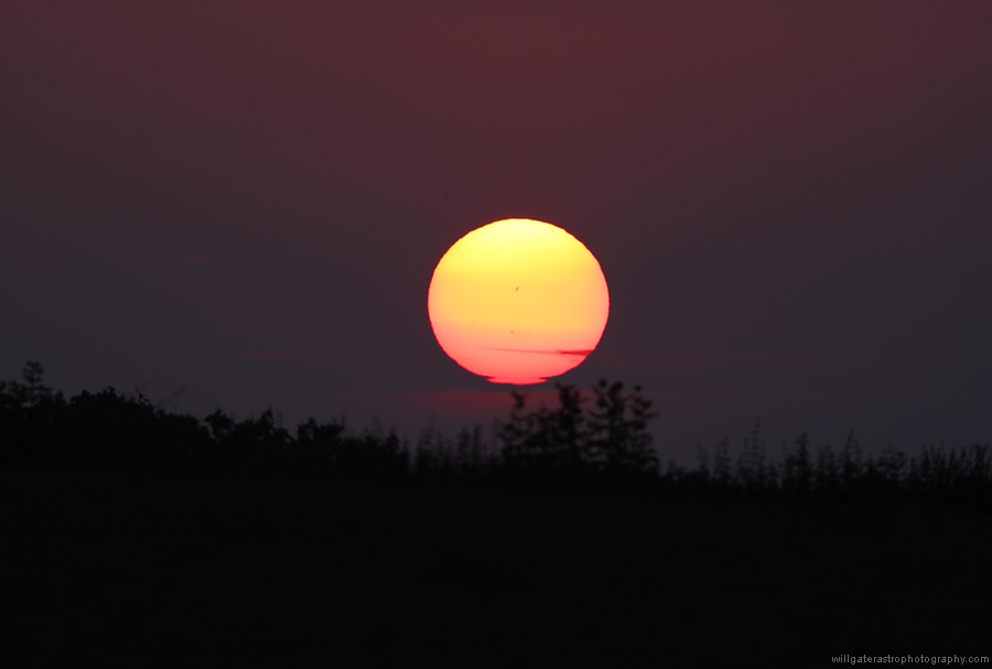 Sunset colours, sunspots and a distorted Sun