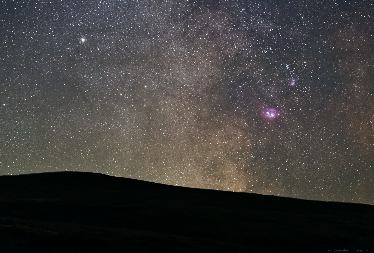 The Galactic Centre setting over the hills of Exmoor, with the Lagoon and Trifid Nebulae (M8 & M20) and the globular clusters M22, M28, NGC 6553 & 6544 (single exposure)