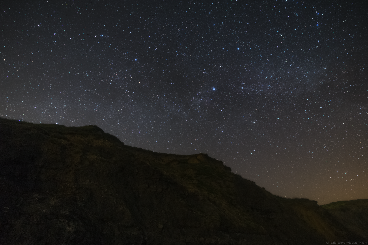 The constellations of Cepheus and Cygnus (showing Deneb and Albireo) over the Jurassic Coast cliffs at Charmouth, UK. Mu Cephei, The Garnet Star, is just left of centre.